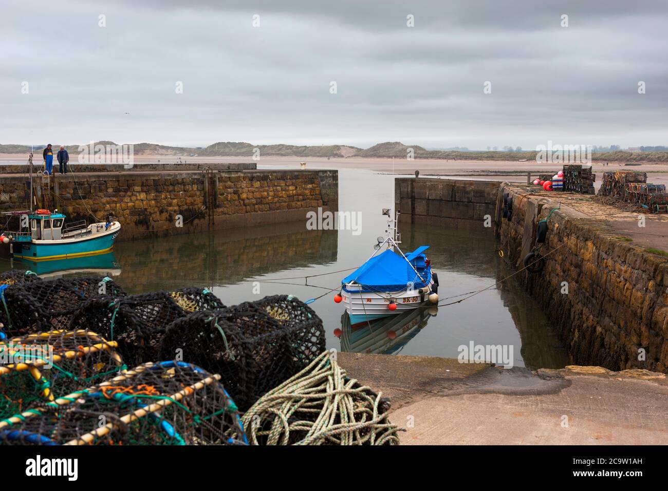 Beadnell Harbour, Northumberland, England, UK: overcast, gloomy day and low tide Stock Photo