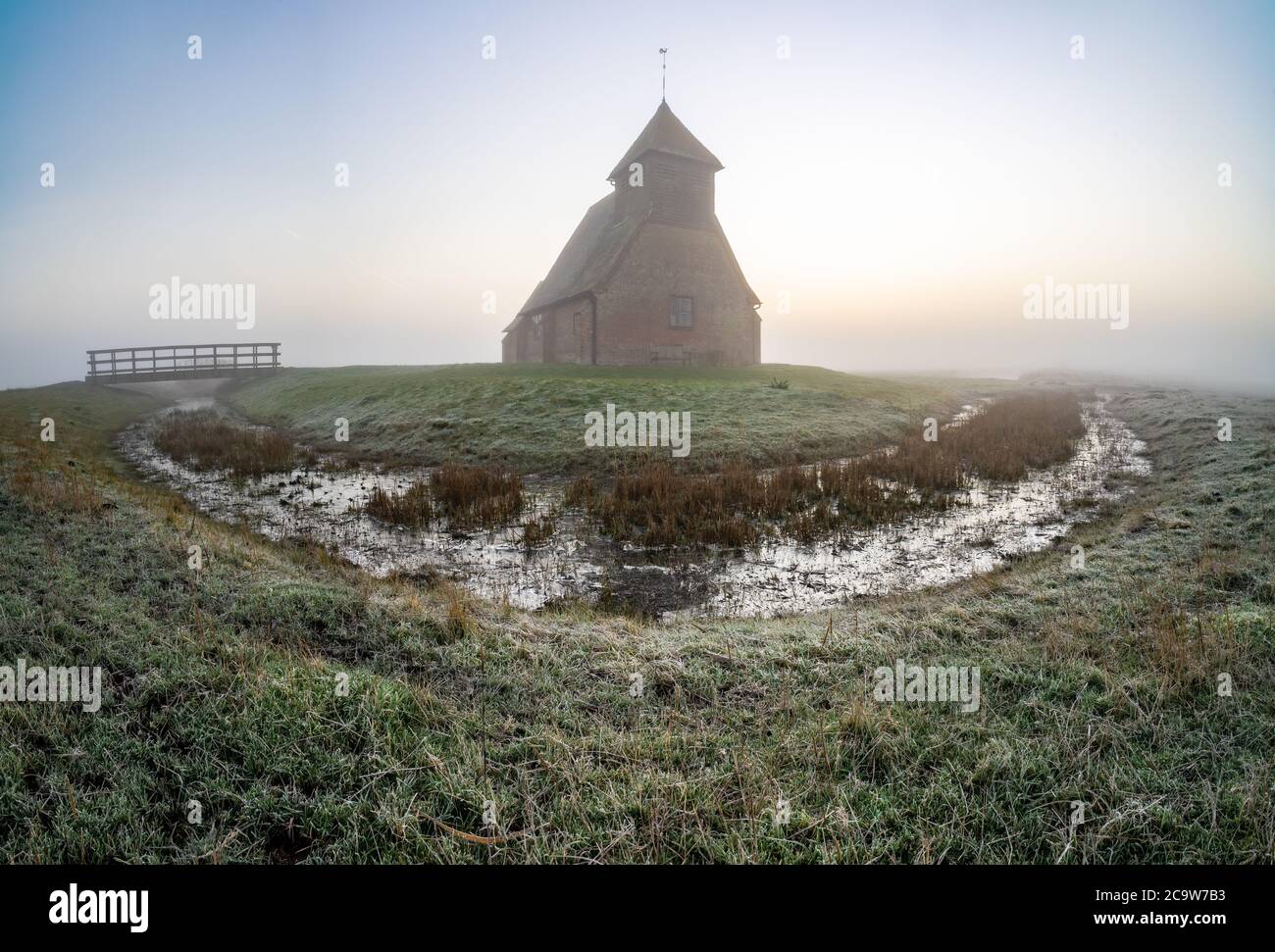 St Thomas à Becket Church in Fairfield at sunrise after the fog moved in. Panoramic image. Stock Photo
