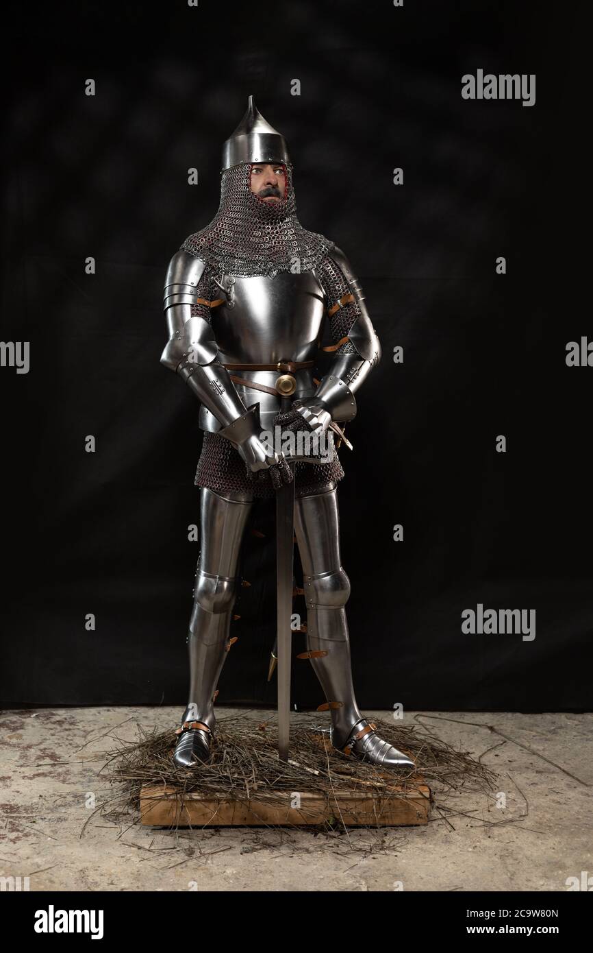 Mannequin man with a beard in a helmet and armor of a knight posing on ...