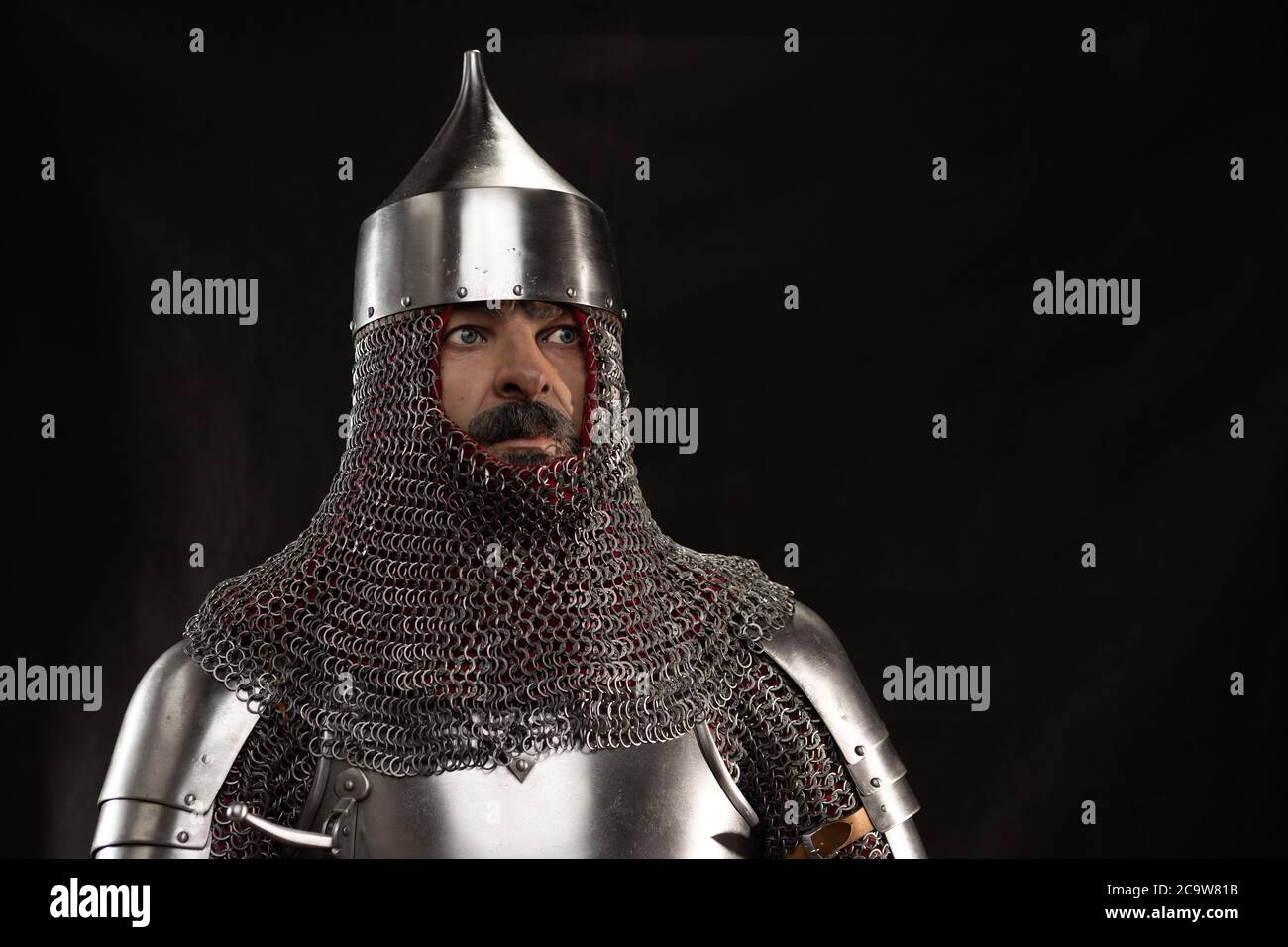 Mannequin man with a beard in a helmet and armor of a knight posing on ...