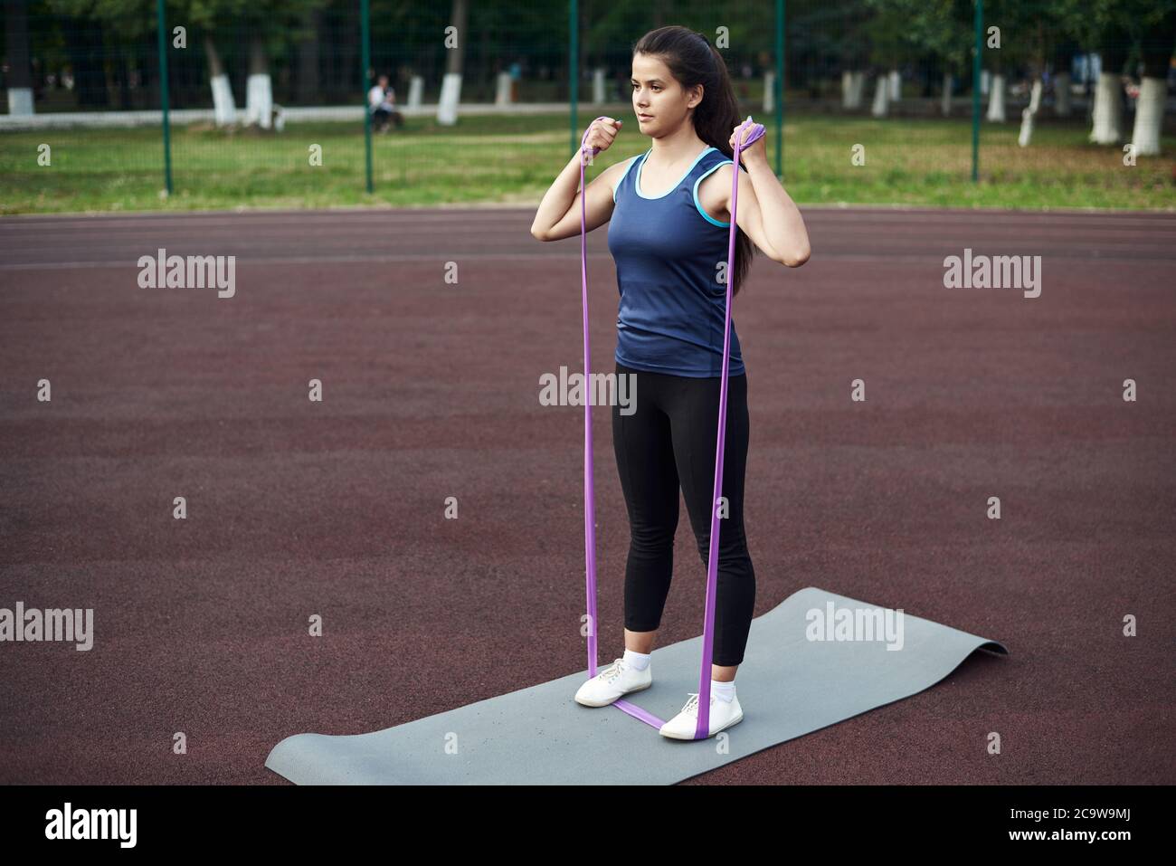 Premium Photo  Attractive young woman training her legs and body with a  strength band. slim female athlete working out her long legs