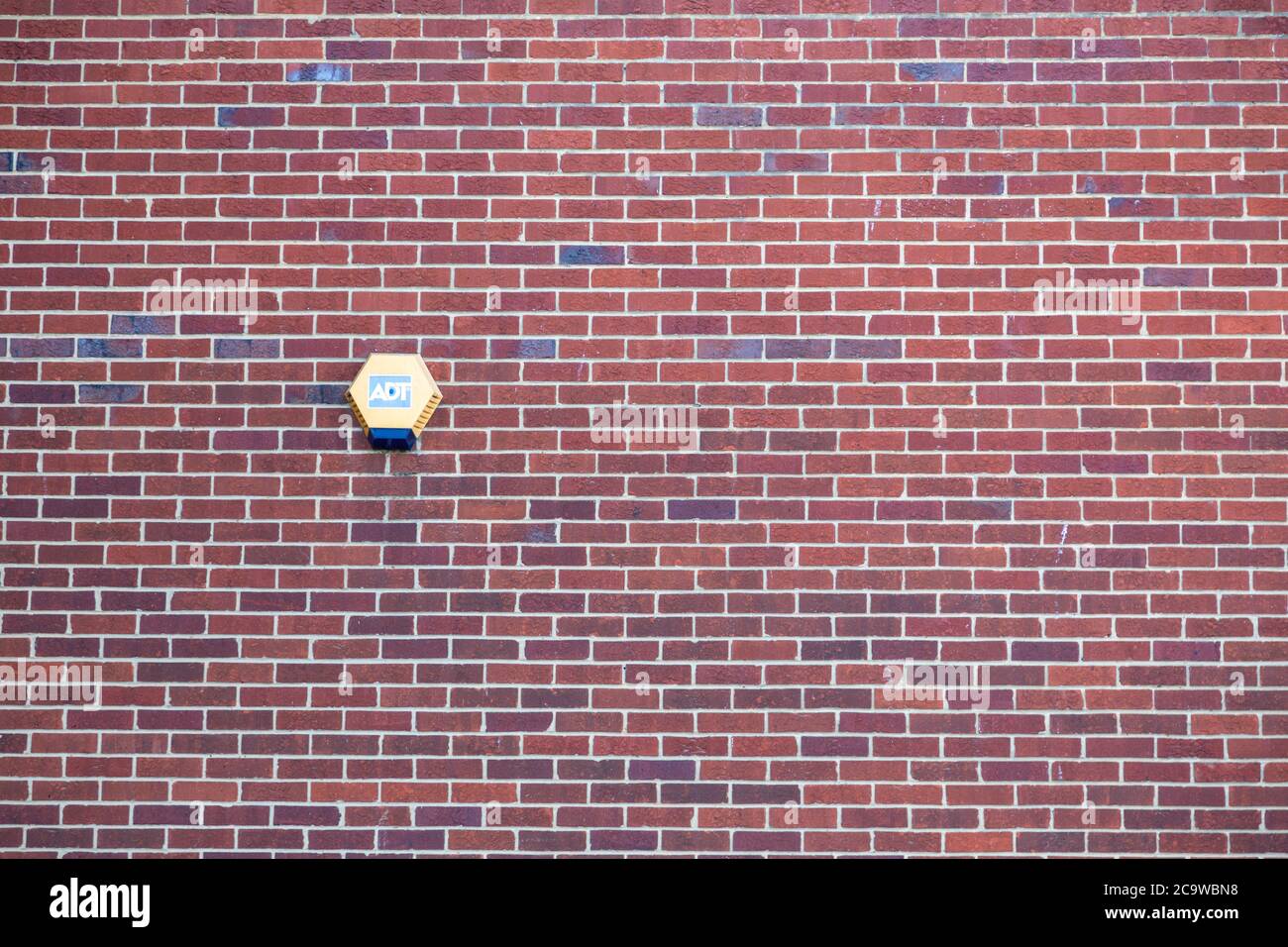 An ADT security alarm on the side of a Brick house Stock Photo