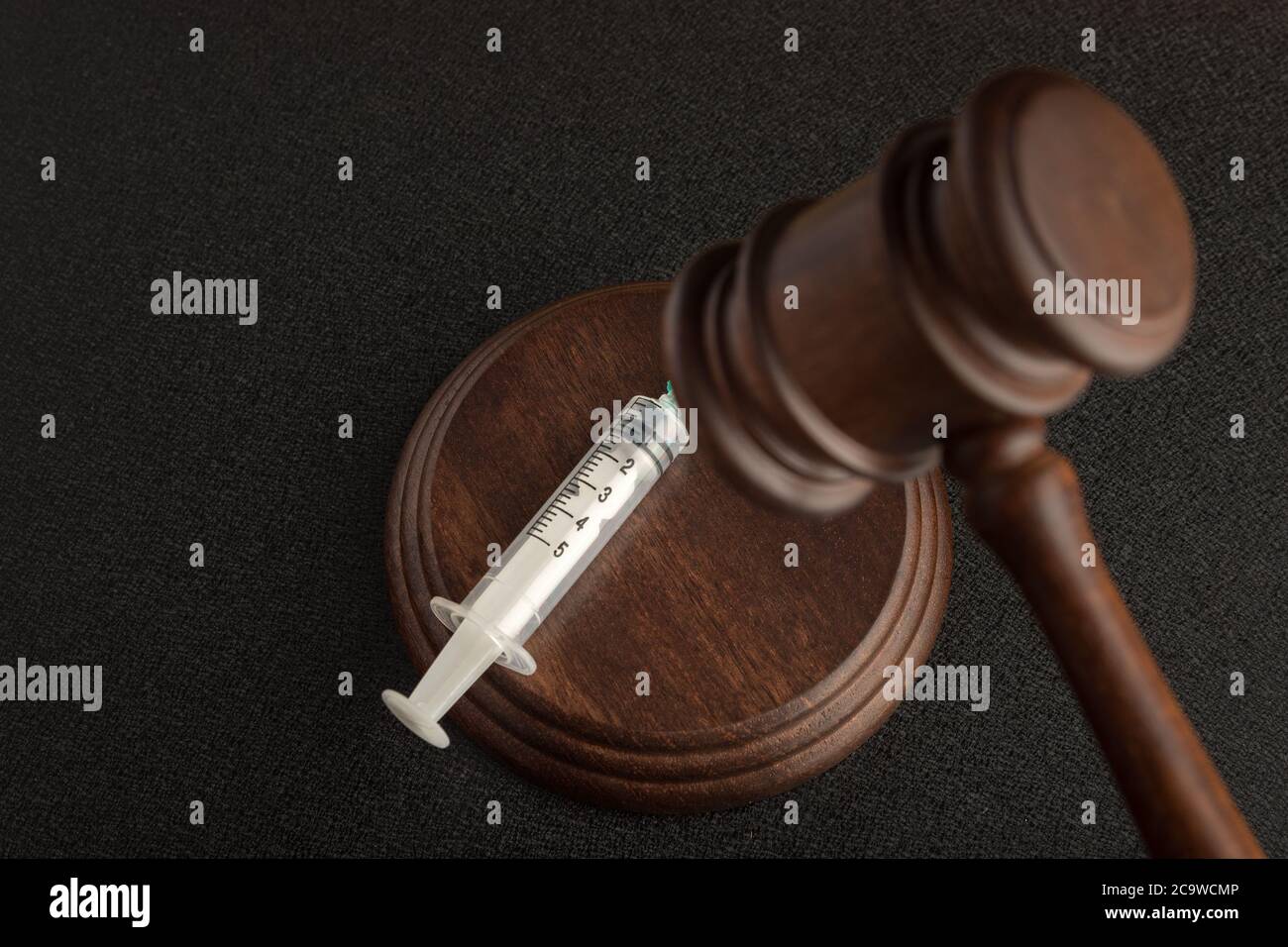 Judicial hammer and syringes. Verdict for distribution of drugs. legal