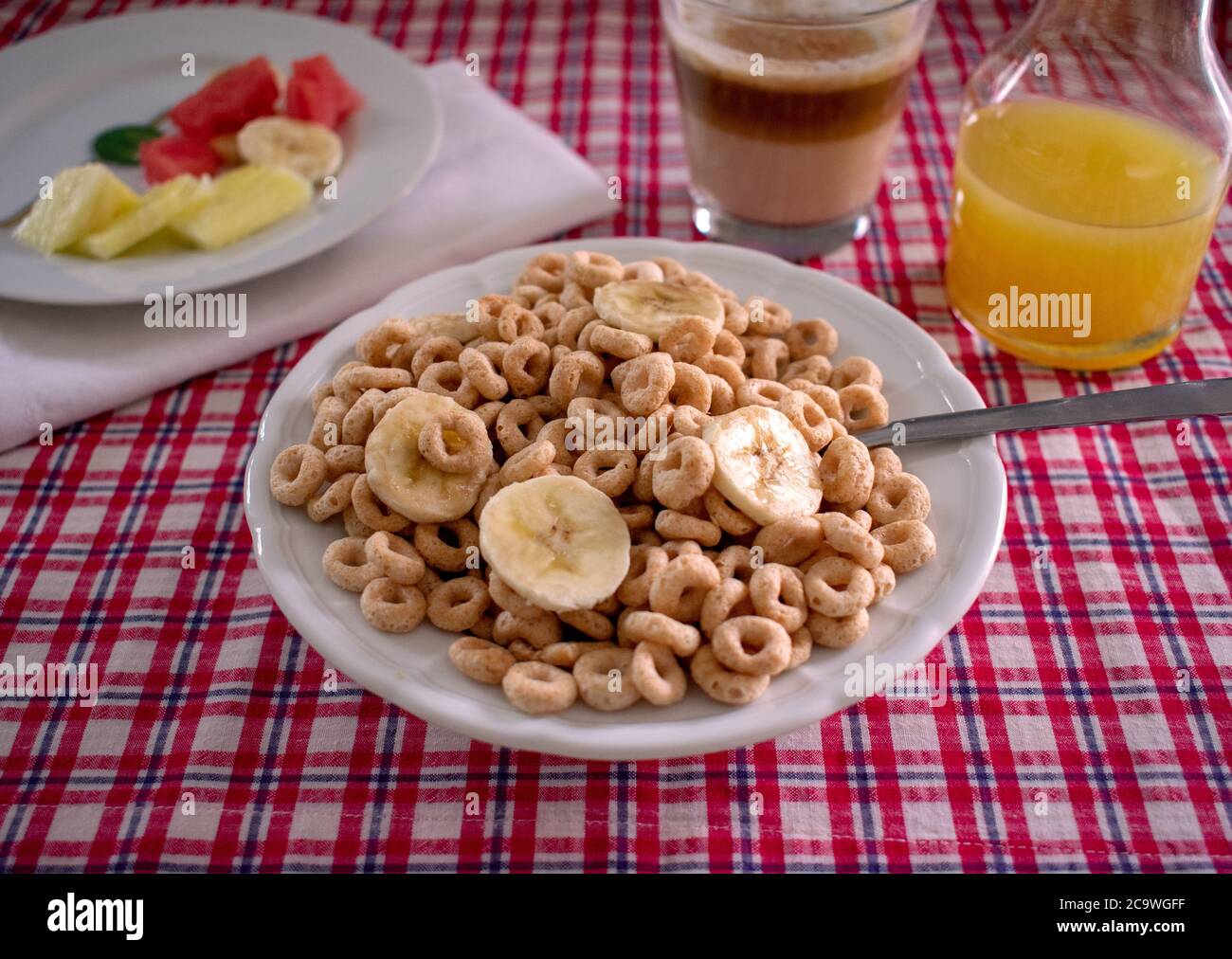 Cereal Bowl with coffee, orange juice, and fruit over picnic tabletop Stock Photo Alamy