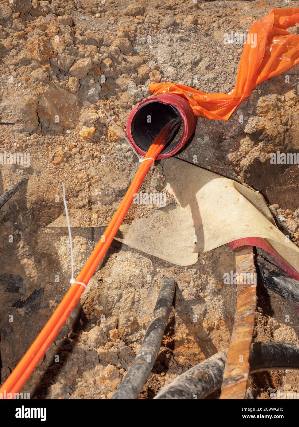 Orange fiber optic cables on a construction site. Building of lines of
