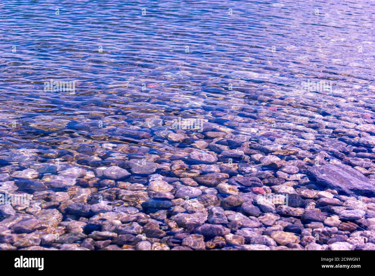 Top view of rocky riverbed under clear fresh water Stock Photo