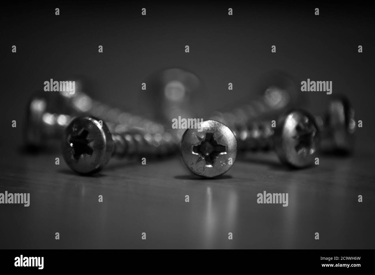 Black and white screws arranged in a circle Stock Photo