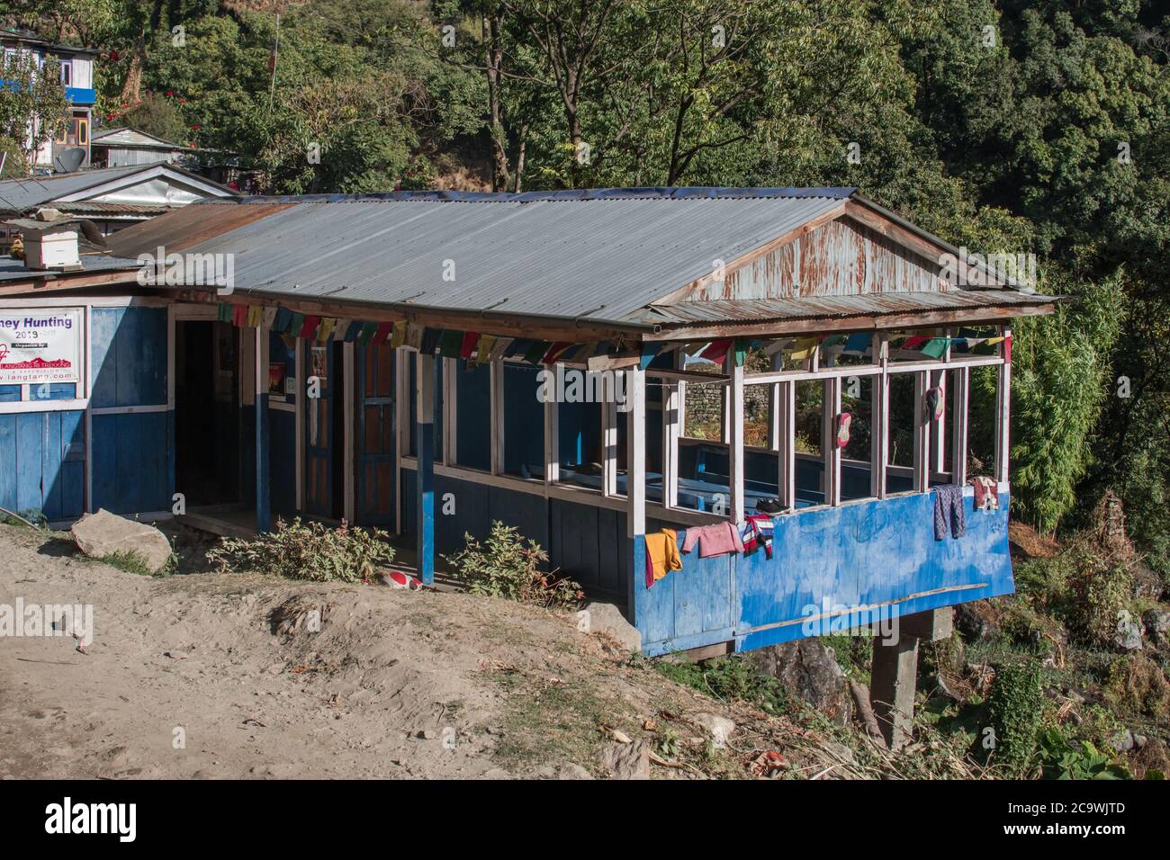 Simple tea house with buddhist praying flags along Annapurna circuit, Nepal Stock Photo
