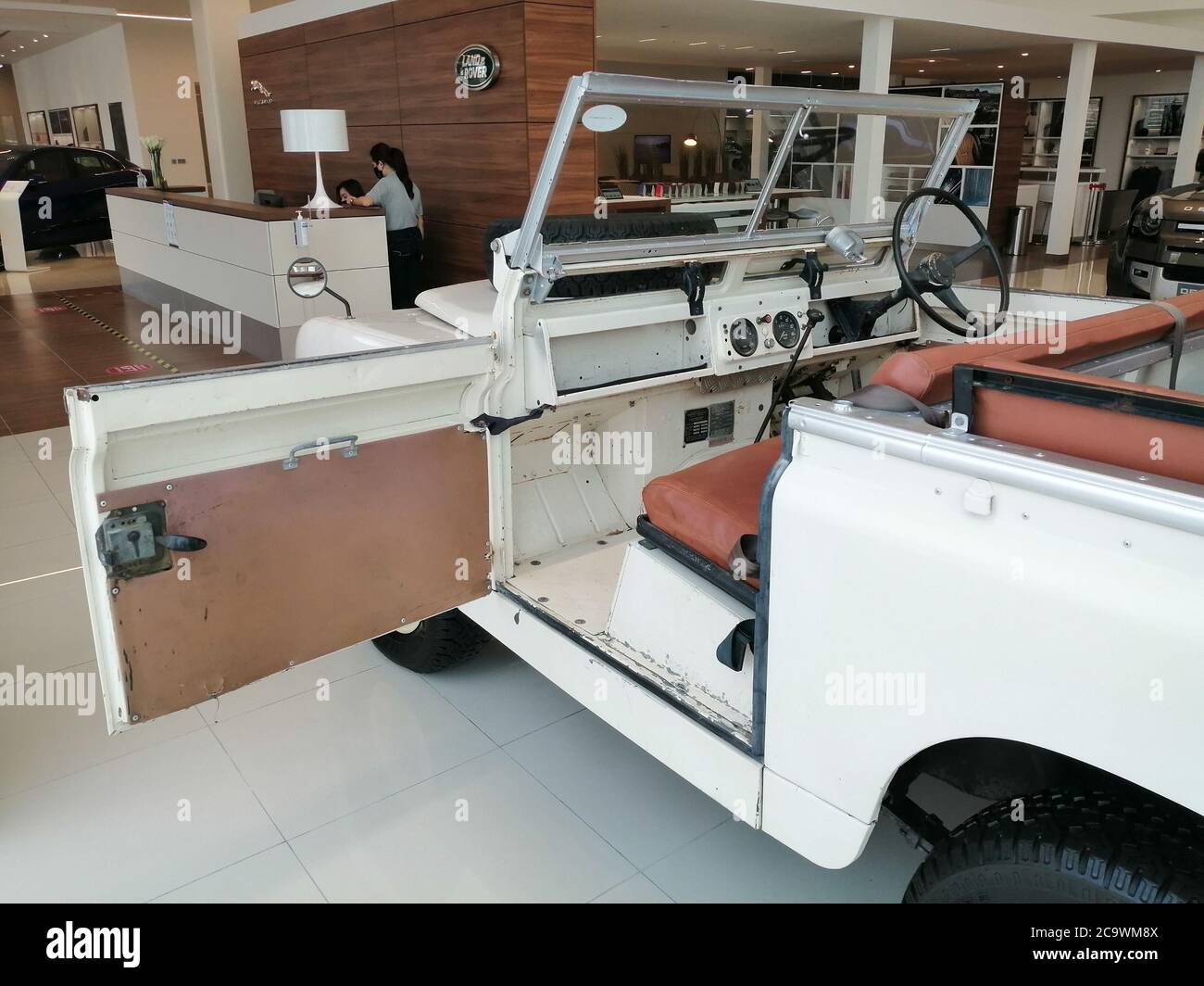 Legacy Land Rover Defender model exhibited in a Land Rover showroom to