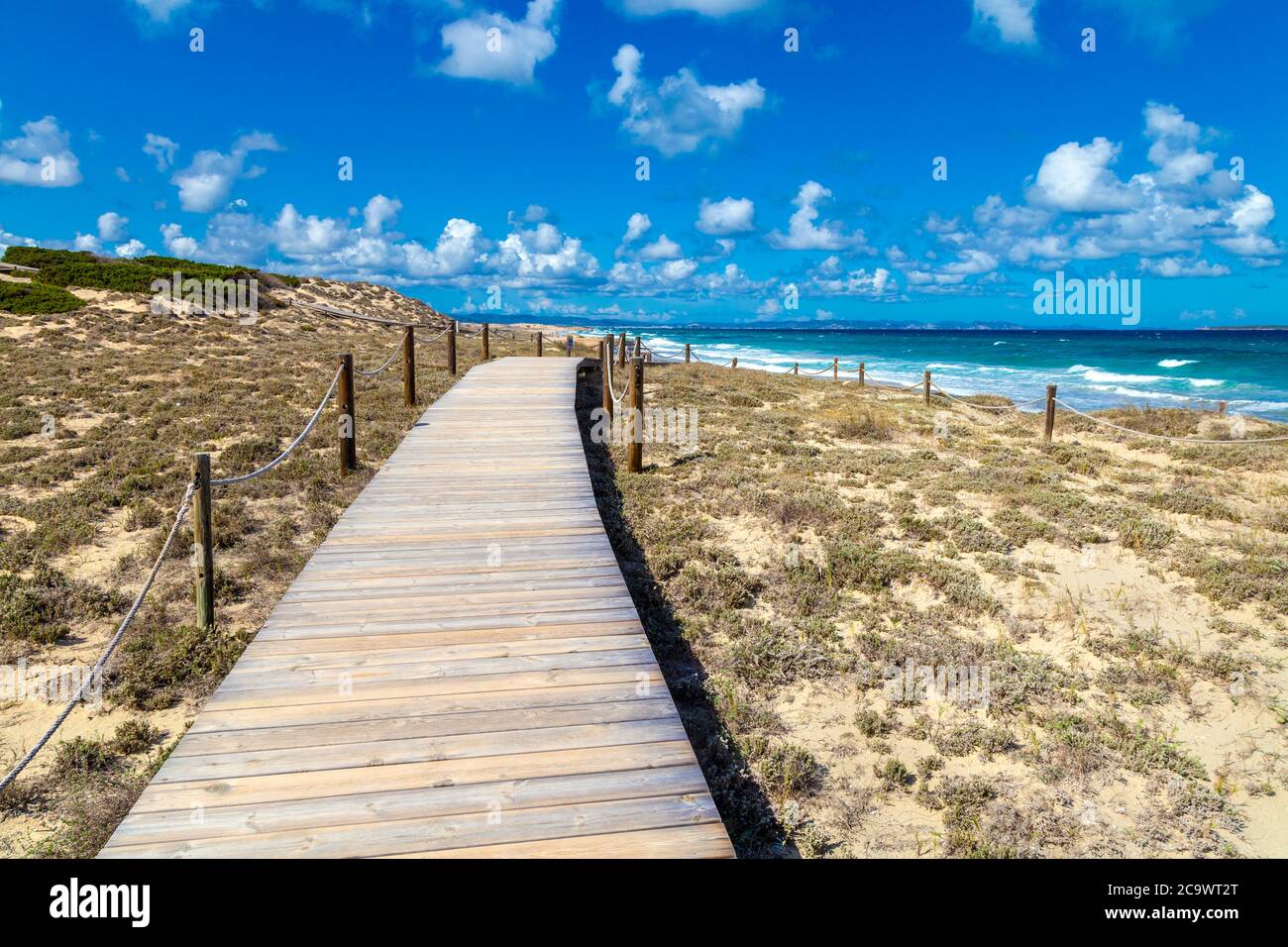 Wooden raised walkway over the protected sand dunes in Platja de Llevant, Formentera, Spain Stock Photo