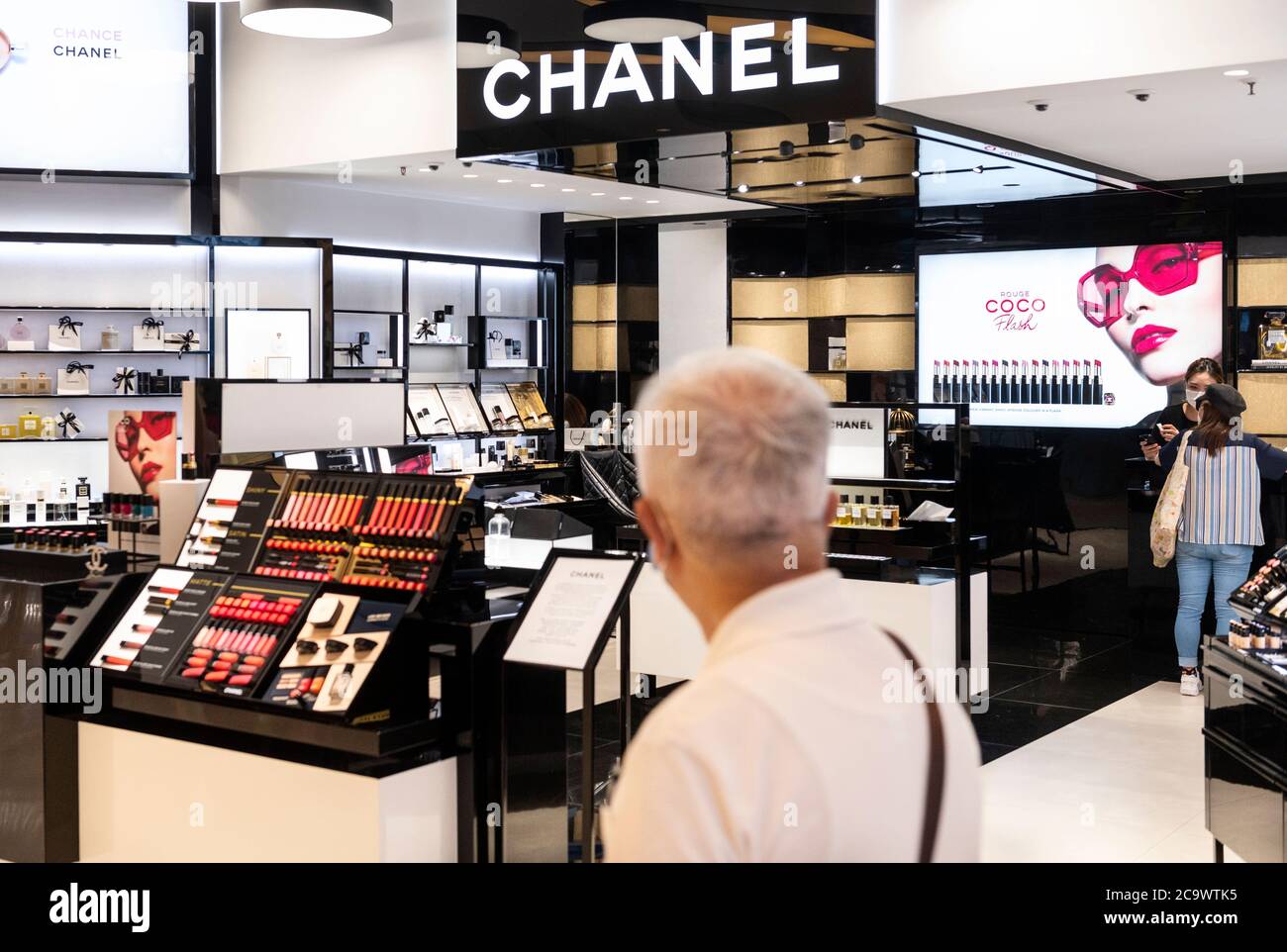 A shopper walks past the French multinational clothing and beauty products  brand Chanel store in Hong Kong (Photo by Budrul Chukrut / SOPA Images/Sipa  USA Stock Photo - Alamy