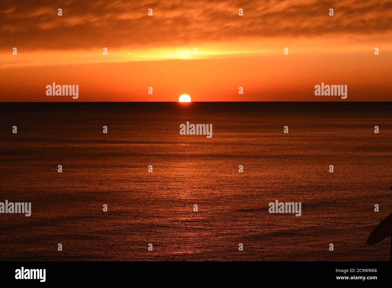 Sun Going Down Over Ocean Stock Photo
