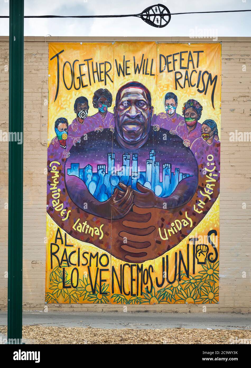 Mural with a portrait of George Floyd  and slogans Together We Will Defeat Racism, Al Racismo Lo Vencemos Juntis, Comunidades Latinas Unidas En Servic Stock Photo