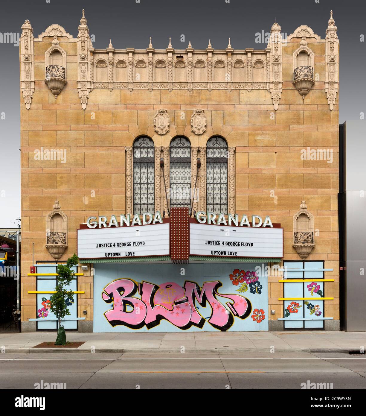 The boarded up exterior of the historic Uptown 1927 Granada Theater due to social protests in Minneapolis, Minnesota.  A BLM Black LIves Matter mural Stock Photo