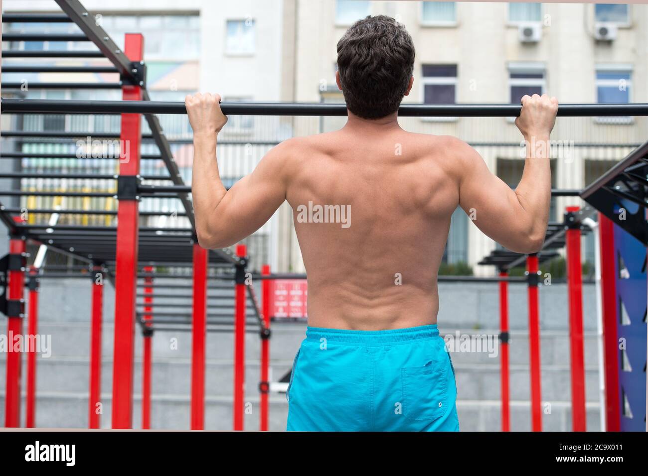 back view of man doing pull up at the gym. concept of sport. exercises