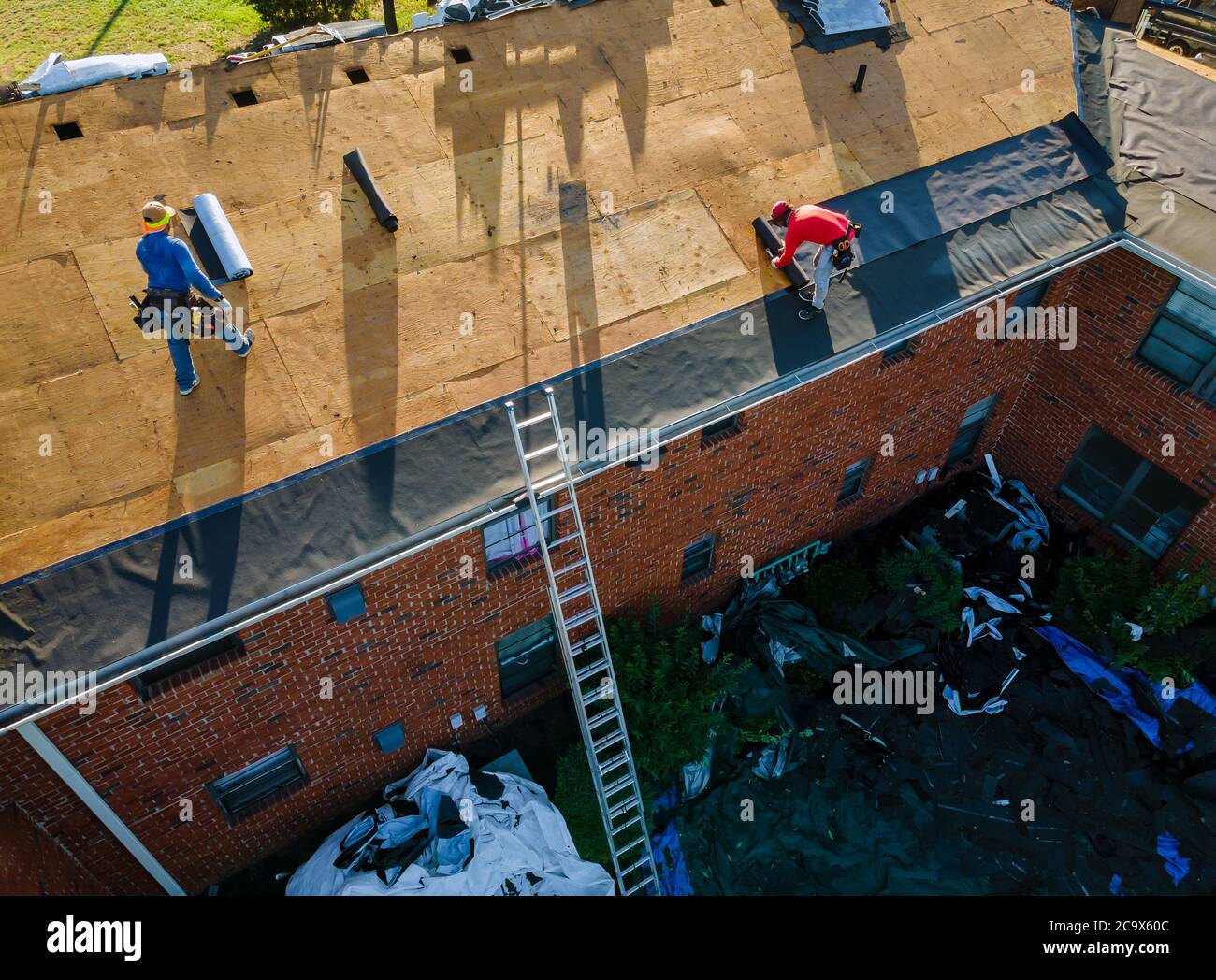 Remove old shingle roof construction worker on a renovation roof the