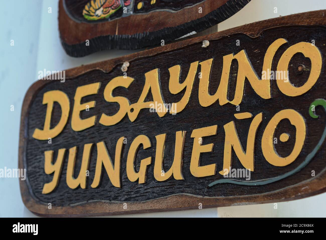 A restaurant sign with the text 'Desayuno yungueño' (breakfast from the Yungas) in a market of Coroico, Bolivia. Stock Photo