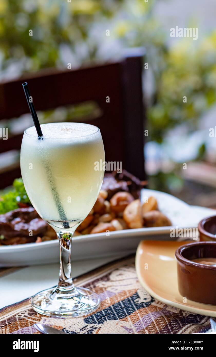 Close up of Pisco Sour cocktail, a typical drink from Peru and Chile served with traditional