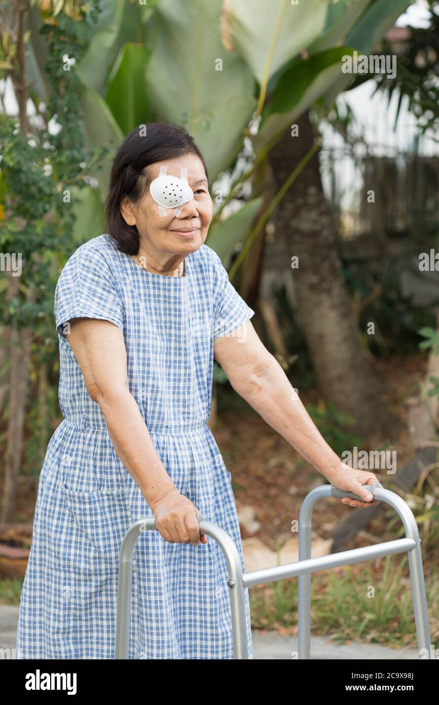 Elderly use eye shield covering after cataract surgery in backyard Stock Photo Alamy