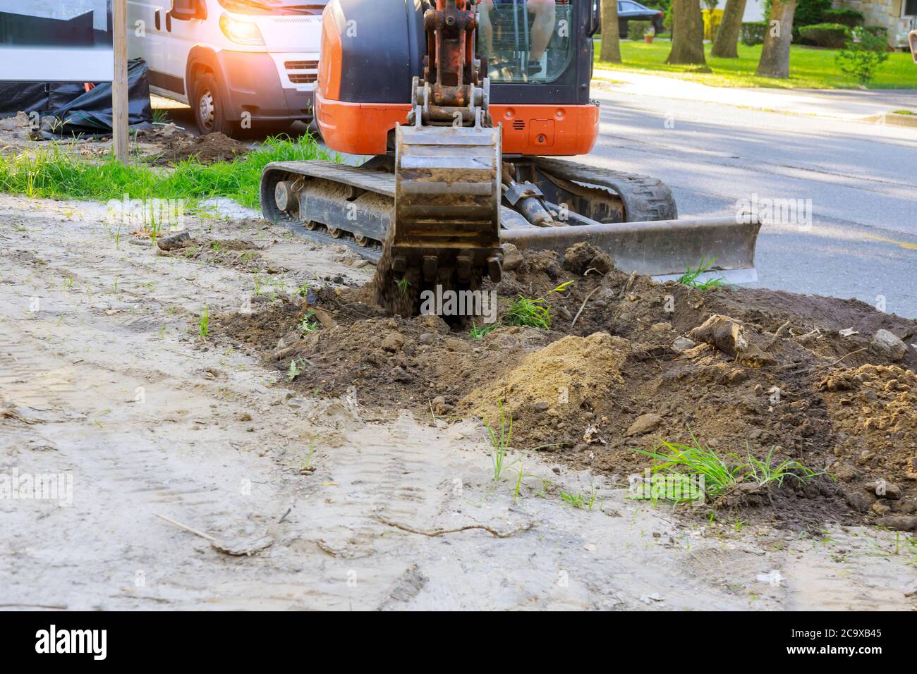 Excavator machine unloading soil earth moving construction works Stock Photo