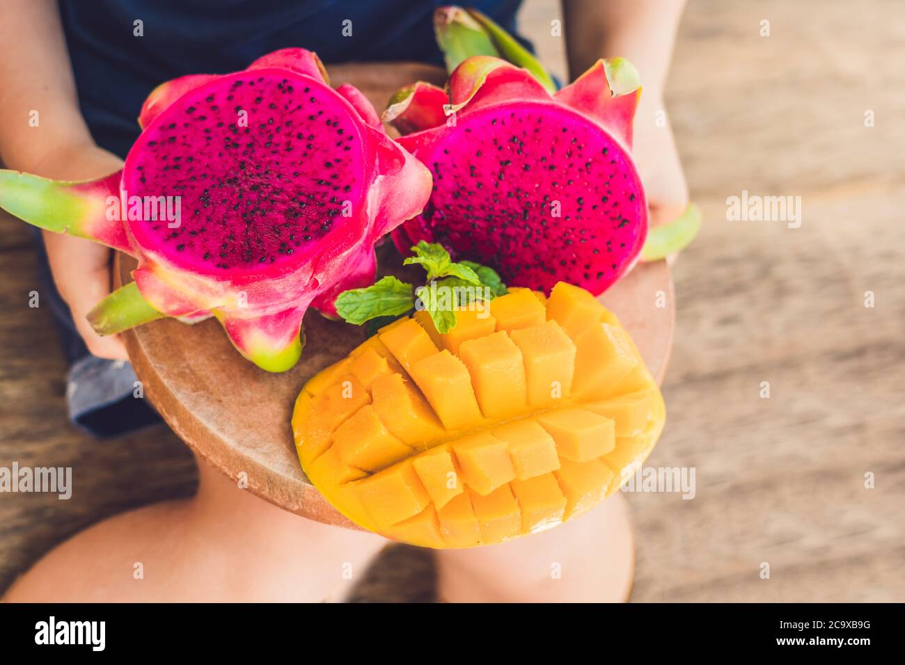 Diced dragon fruit and mango in the hands of the boy Stock Photo Alamy