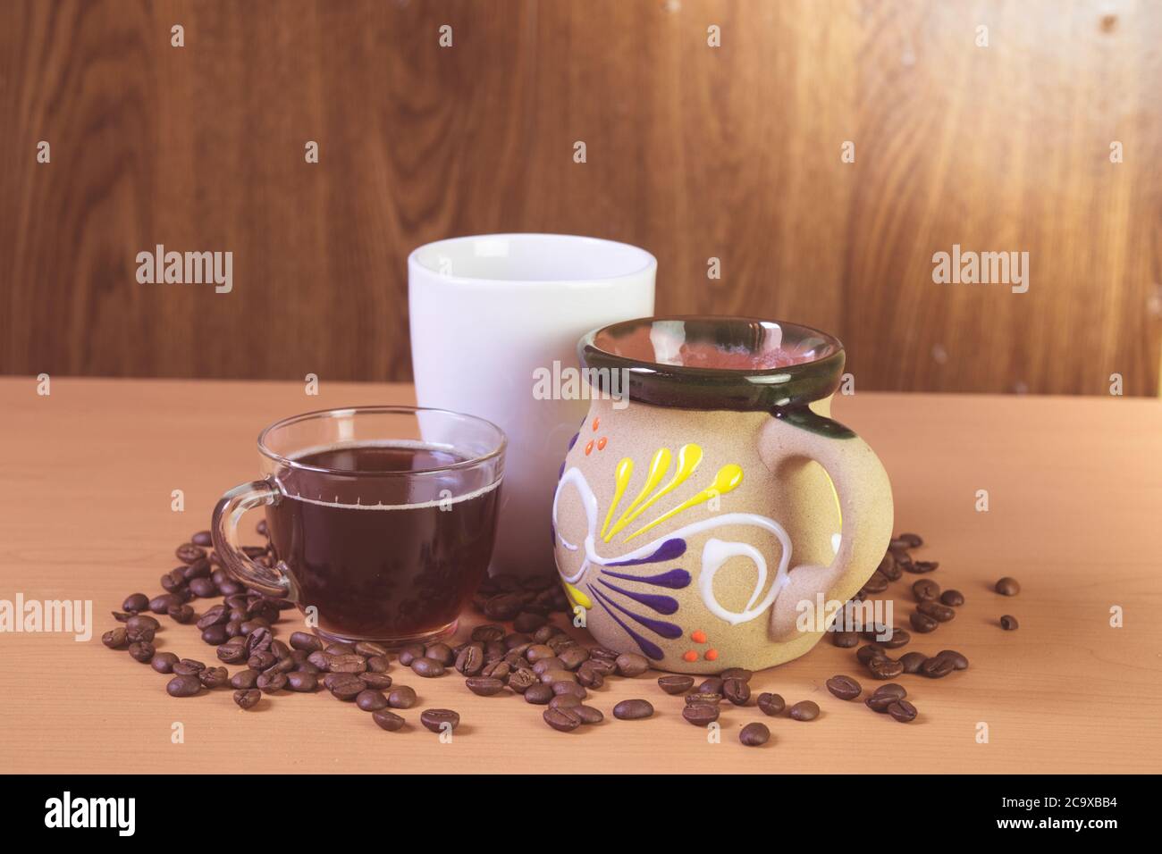 coffee cups with coffee beans on the table. Stock Photo