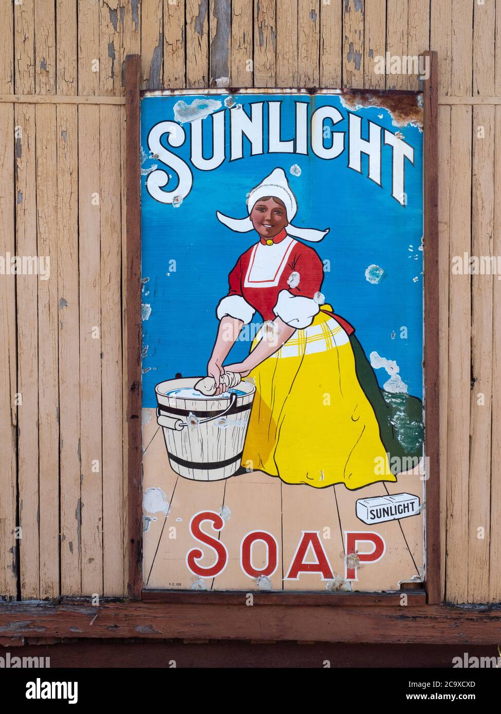 Vintage Sunlight Soap advert painted on metal against a wooden background. Coal Creek, Korumburra, Australia Stock Photo