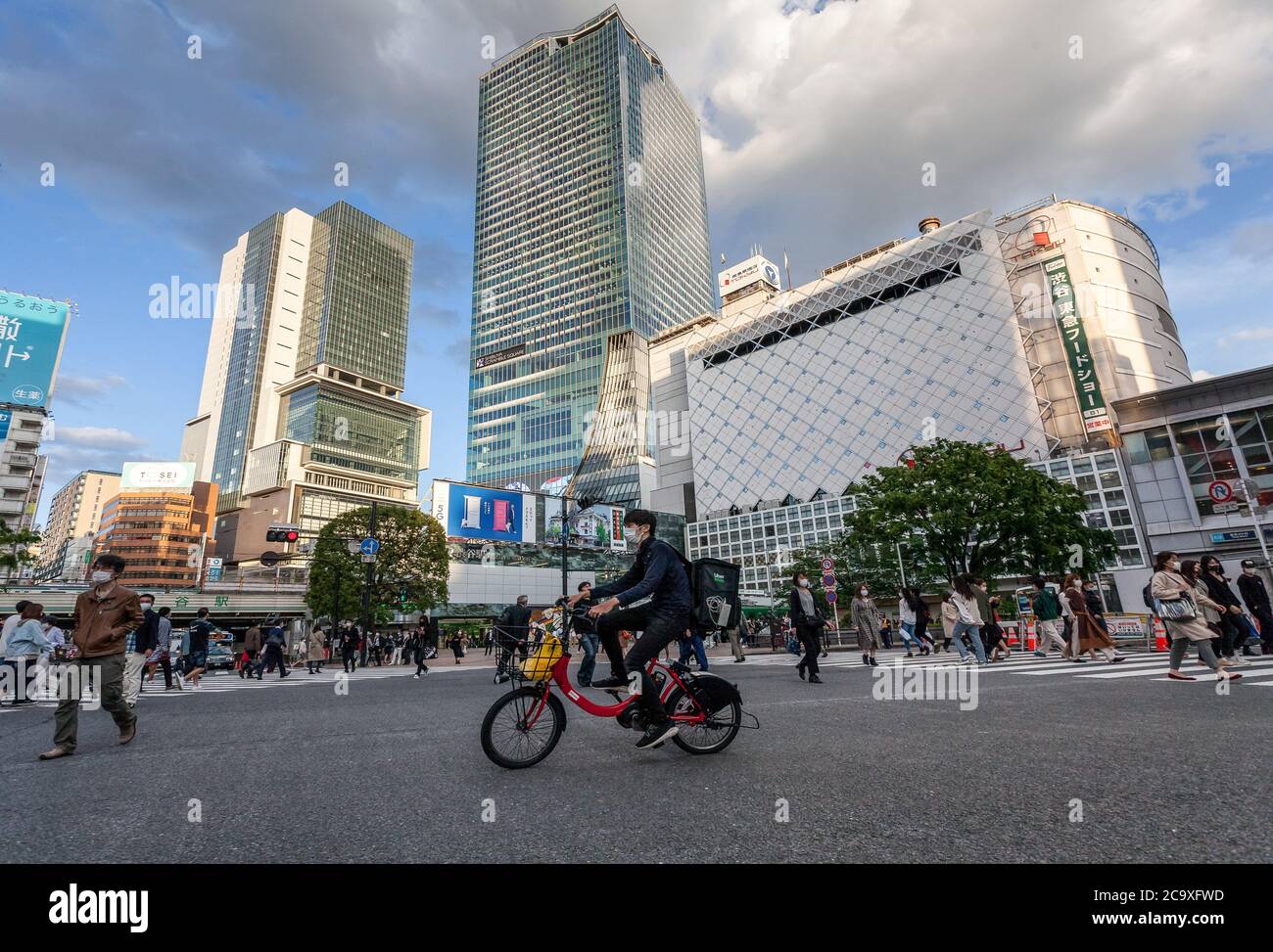 An Uber Eats Delivery Man Rides His Rental Bicycle Through A Quieter Shibuya Crossing Amid Coronavirus Crisis The Two Month Long State Of Emergency Declared By The Japanese Government In Response To The