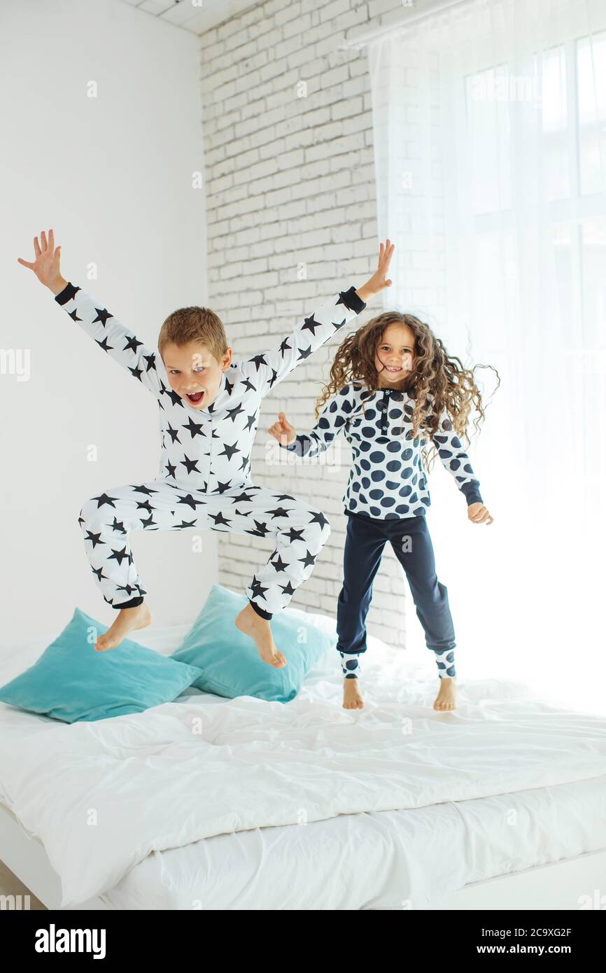 Children jump on the bed Stock Photo Alamy