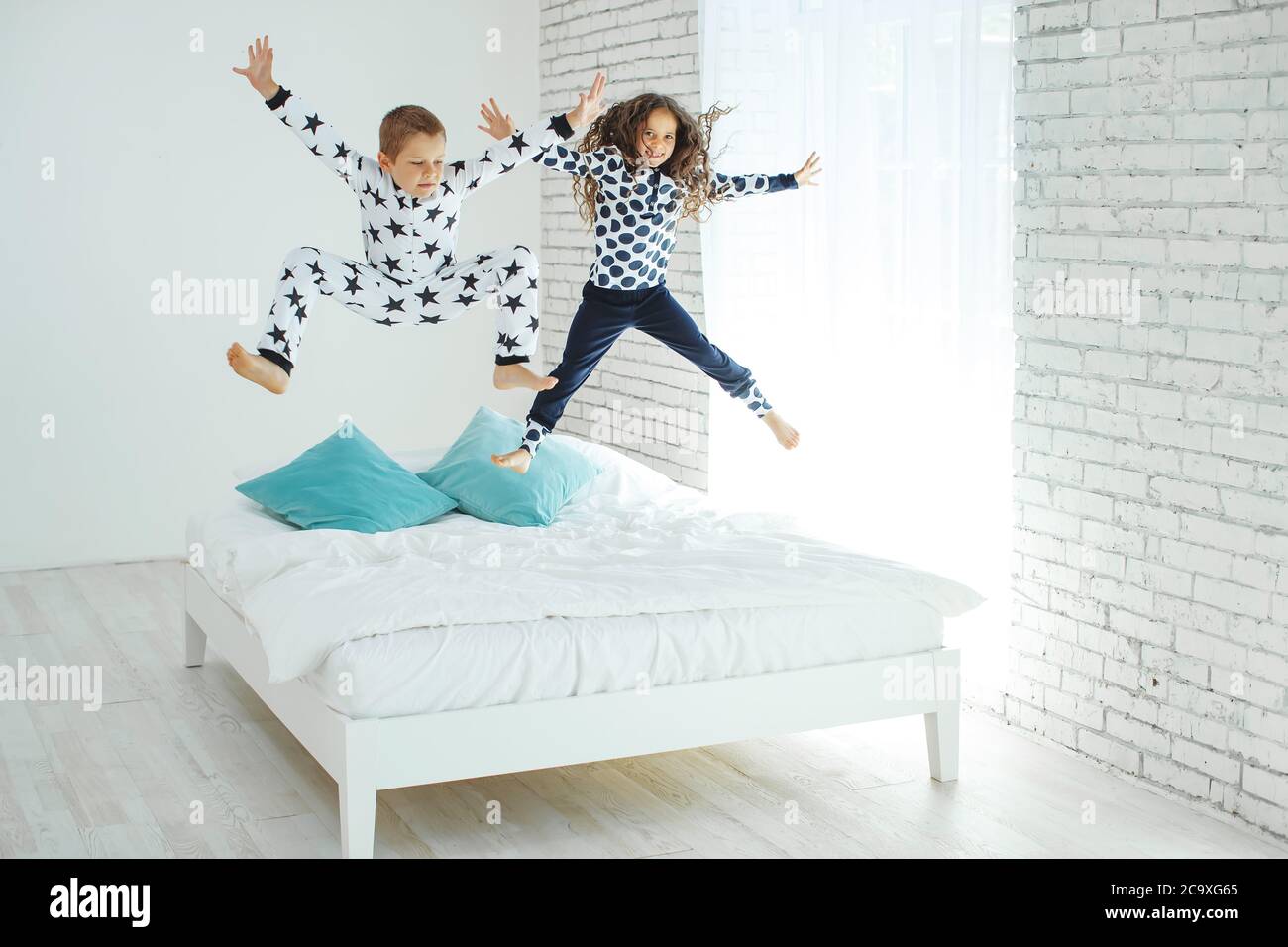 Children jump on the bed Stock Photo Alamy