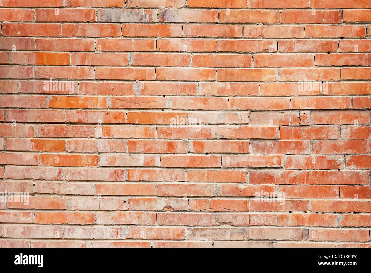 red wall of worn dirty broken bricks Stock Photo