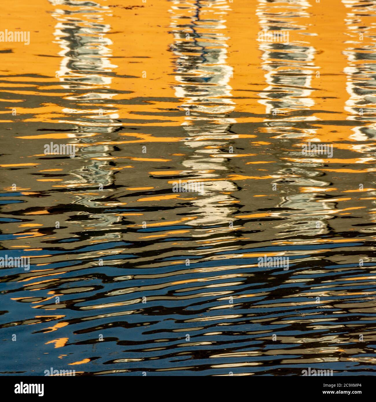 Reflection of a orange building in water Stock Photo