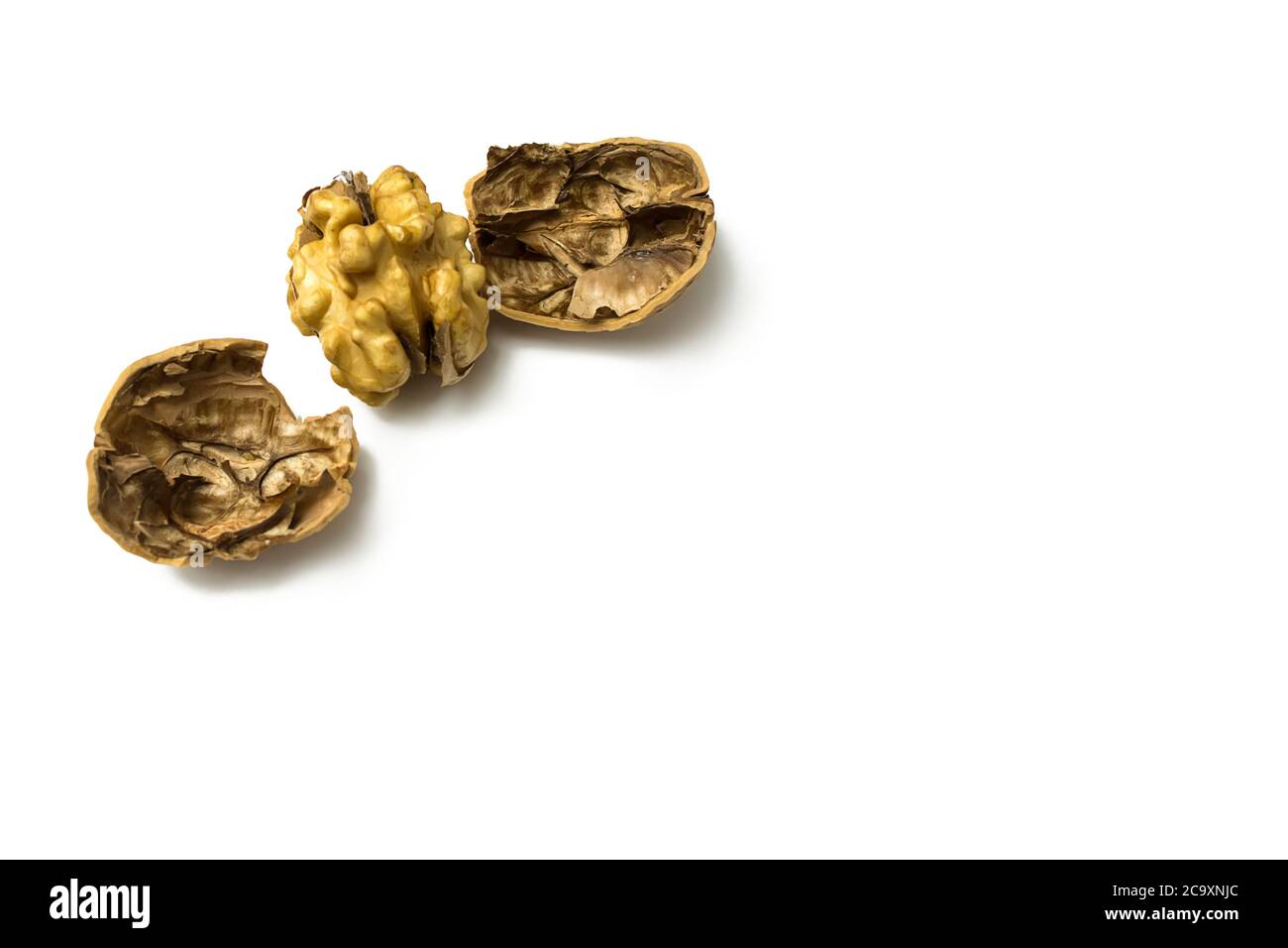 Close-Up Of Crushed Walnuts With Nutshell Isolated On White Background Stock Photo