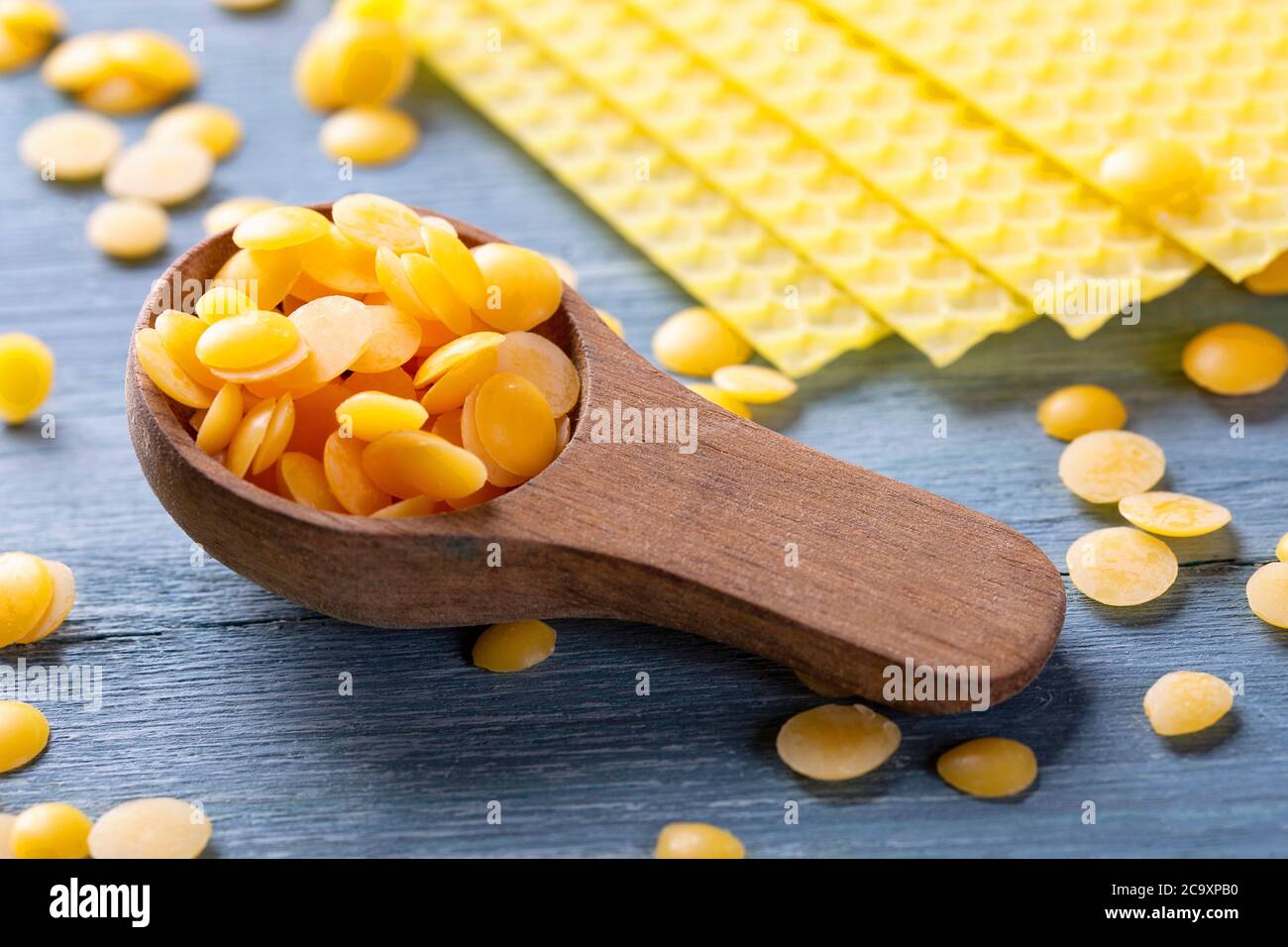Beeswax pellets in the spoon Stock Photo