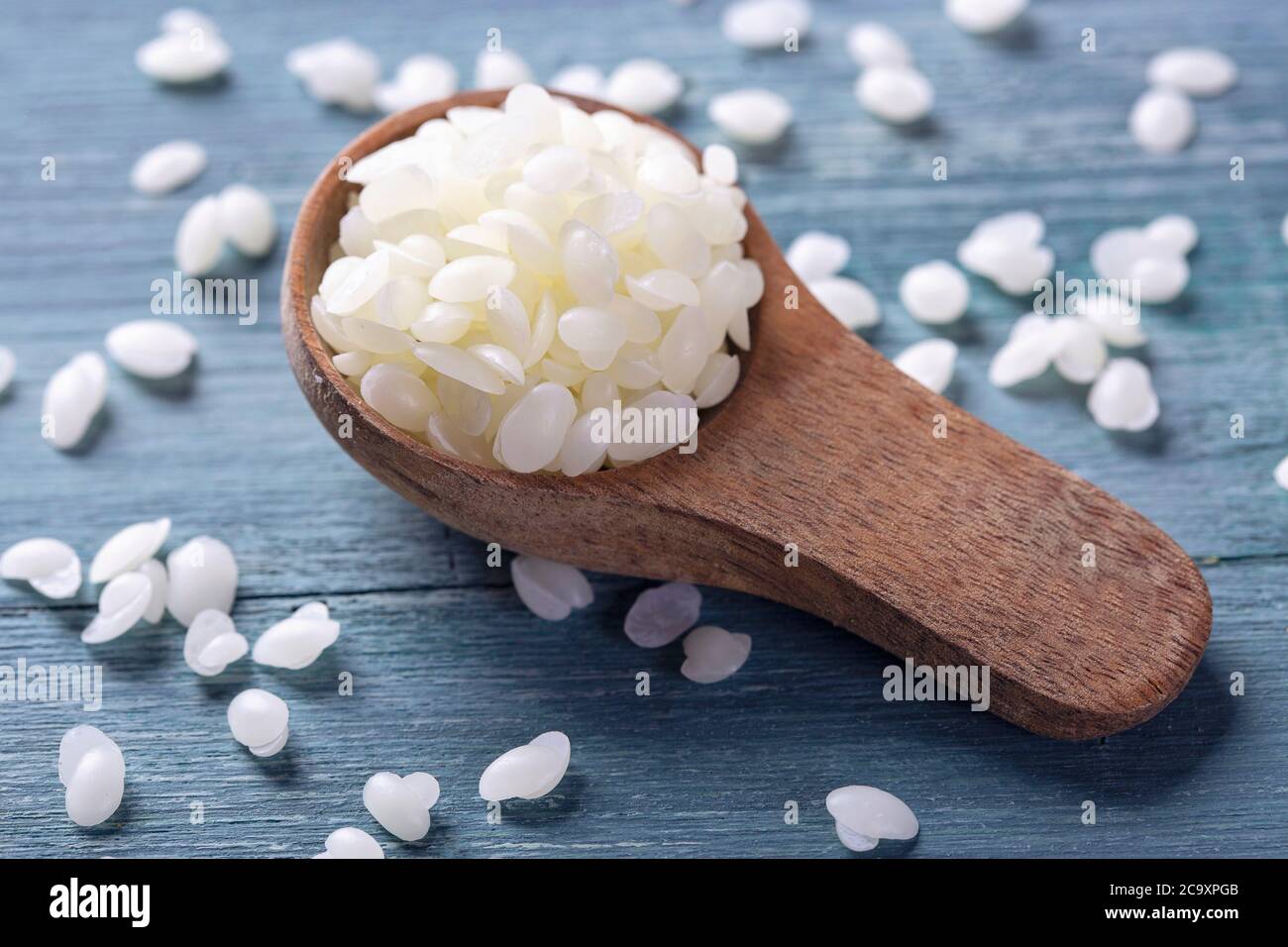 Beeswax pellets in the spoon Stock Photo