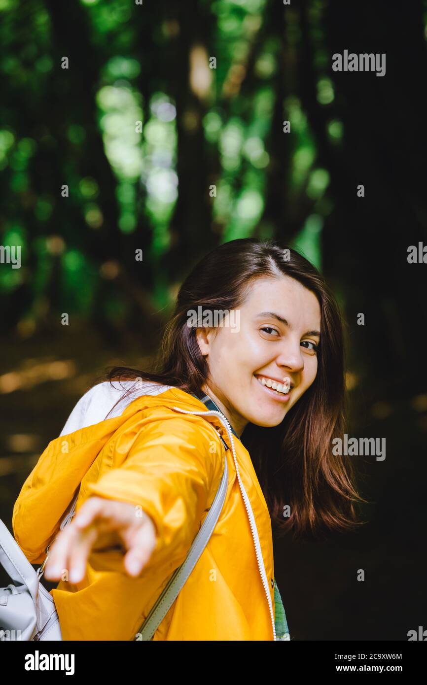 smiling pretty woman portrait in yellow raincoat Stock Photo - Alamy