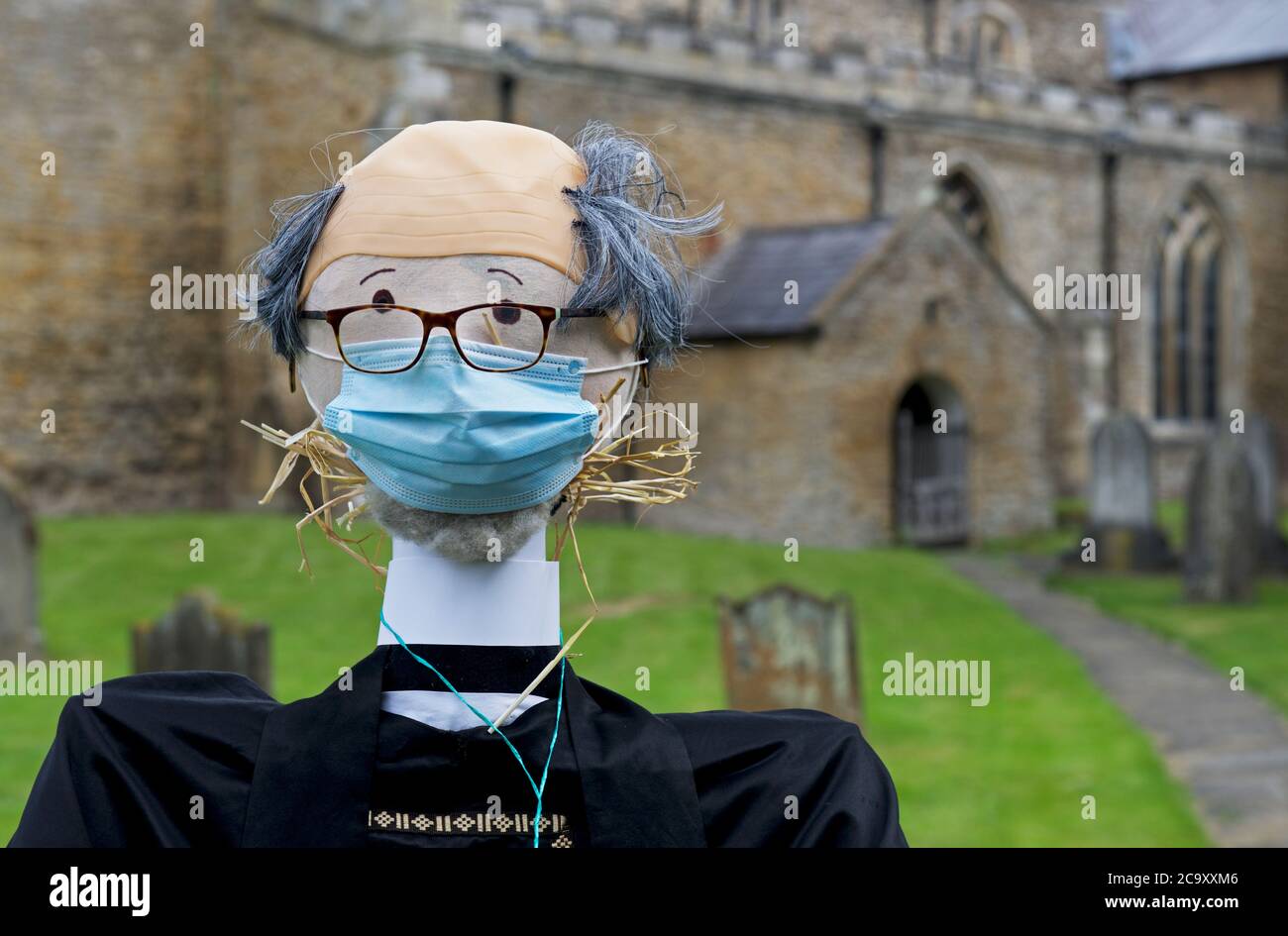 Scarecrow vicar in the churchyard of All Saints Church in the village of North Cave, East Yorkshire, England UK Stock Photo
