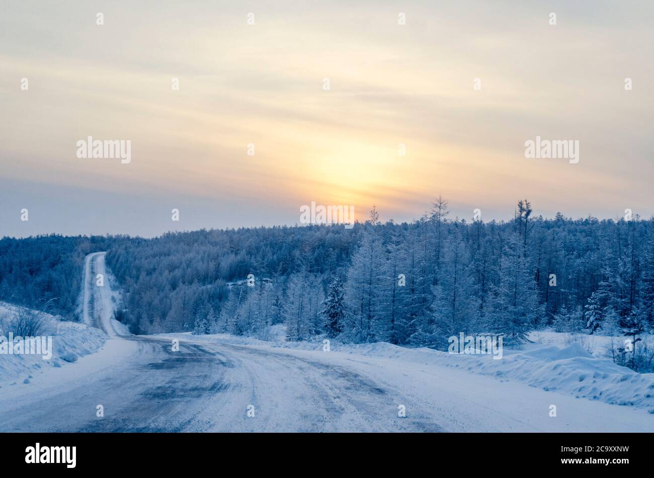 The R504 Kolyma Highway is also known as the Road of Bones. Winter road on a sunset background