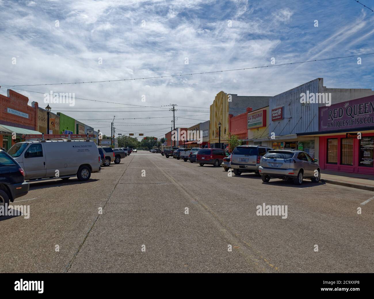 Shops and Stores line a straight side street in the Texas town of Rosenberg on a sunny day in March. Stock Photo