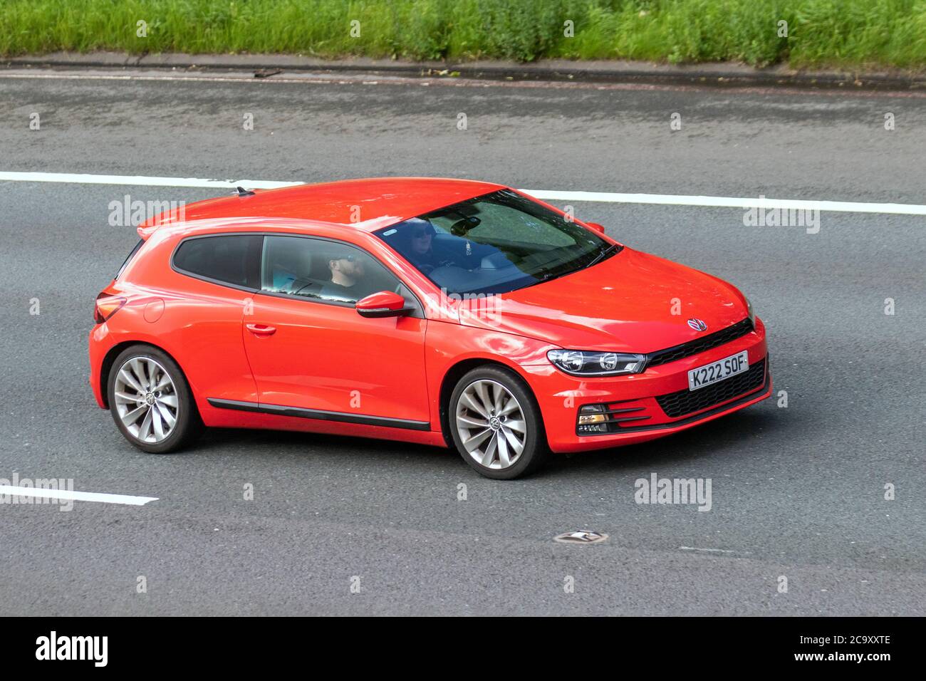 2014 red vw Volkswagen Scirocco Coupe 2.0 TDi (184bhp) BlueMotion Tech GT  3d ; Vehicular traffic moving vehicles, cars driving vehicle on UK roads,  motors, motoring on the M6 motorway highway network