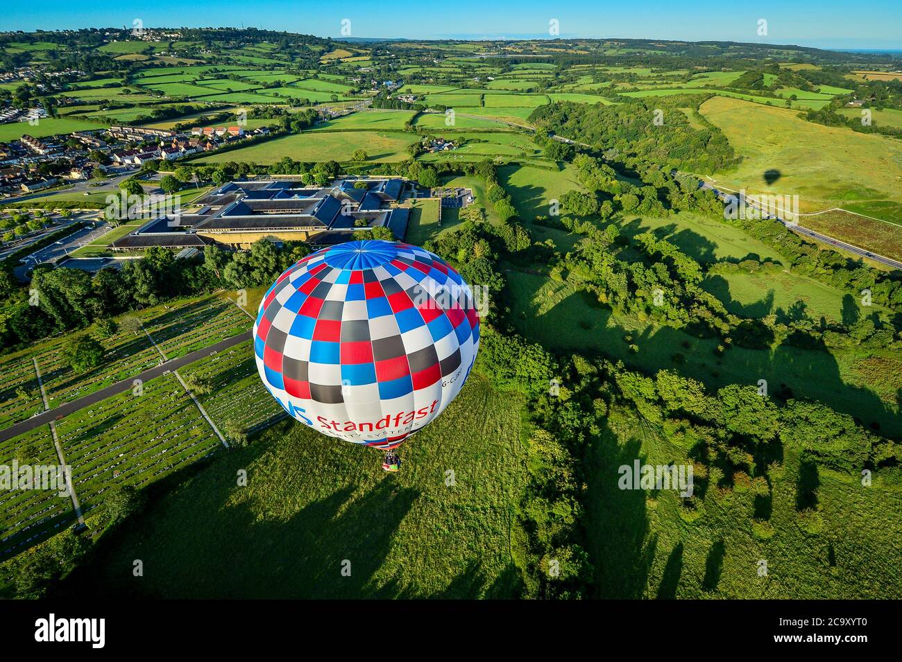 A hot air balloon flies over South Bristol as part of a mass ascent, with 43 balloon teams taking part, for a Fiesta Flypast over the city as part of the socially distanced alternative to the Bristol International Balloon Fiesta 2020. Stock Photo