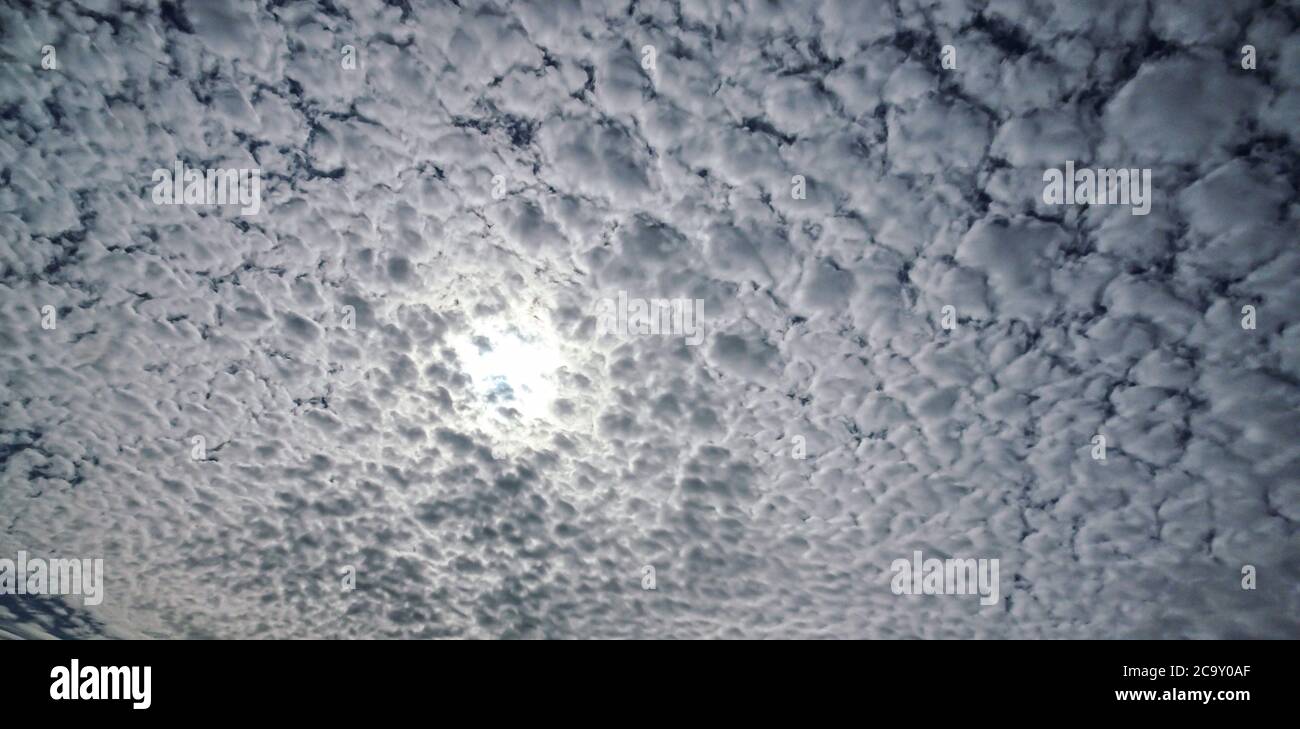 Stratocumulus cloud dense covering the suns glow Stock Photo
