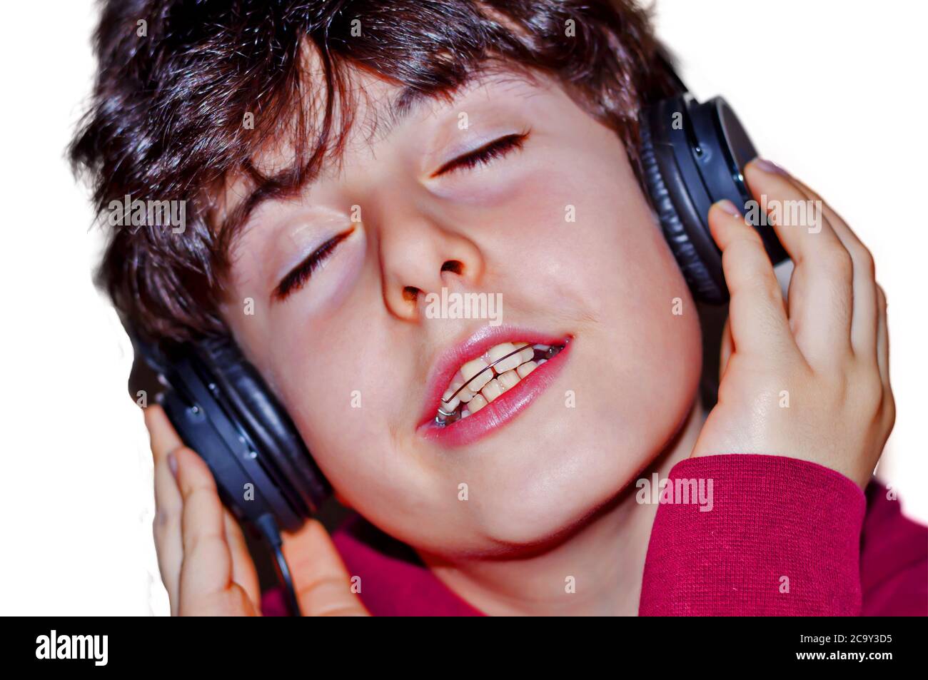 Portrait of happy boy with braces is listening music Stock Photo Alamy