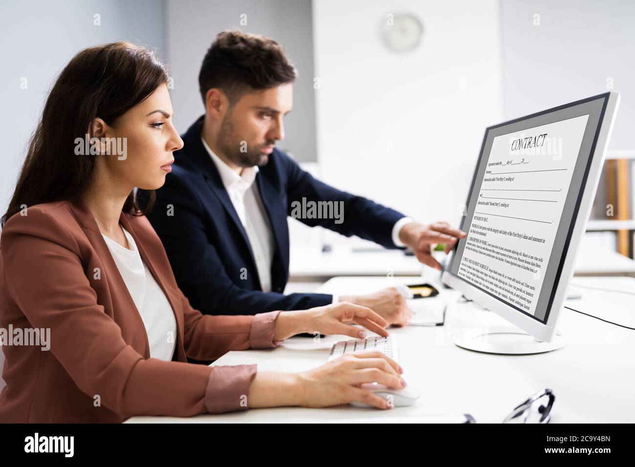 Reading Legal Law Contract On Desktop Computer Screen Stock Photo