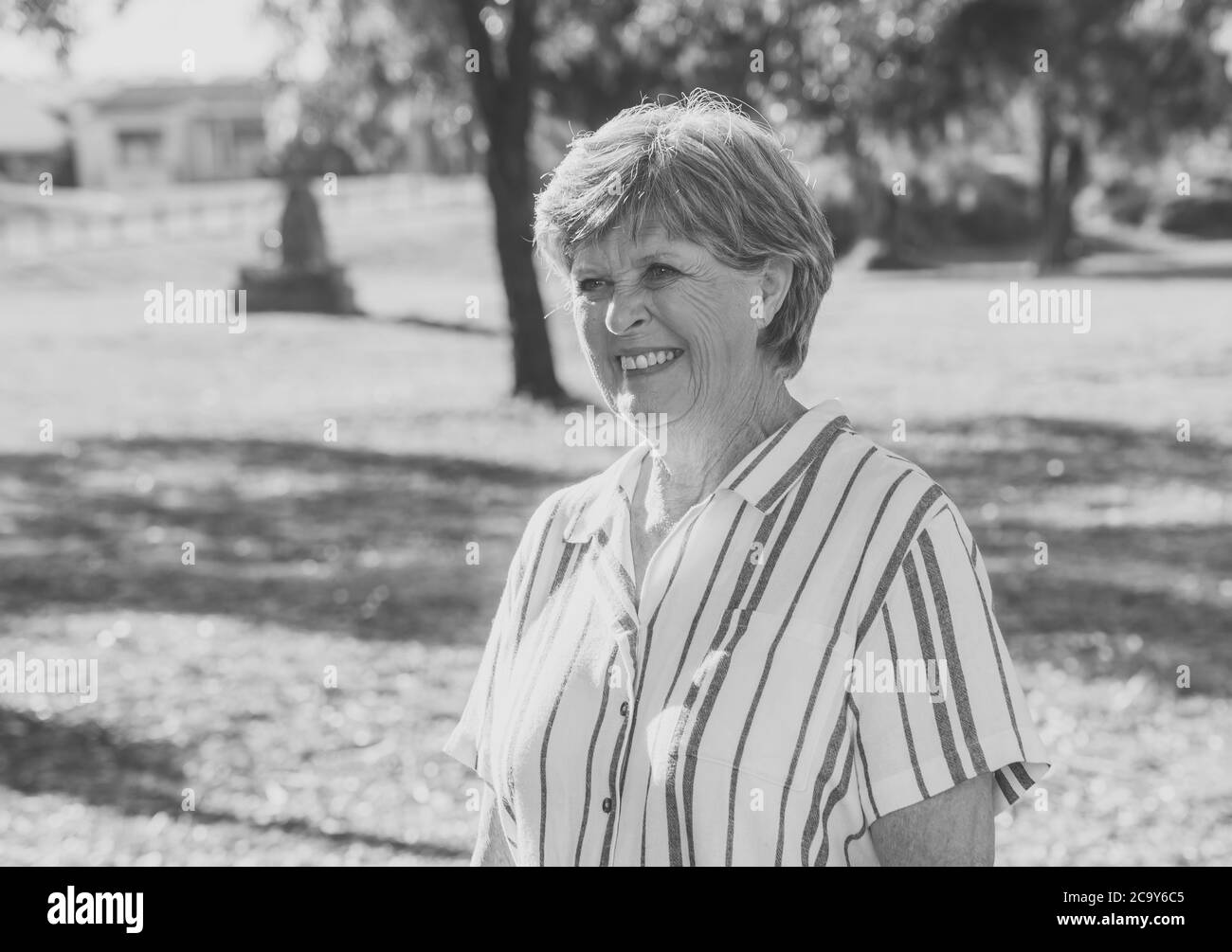 Outdoors portrait of Beautiful retired older woman at the park on sunset enjoying her freedom feeling happy and lucky in healthy and active lifestyle Stock Photo
