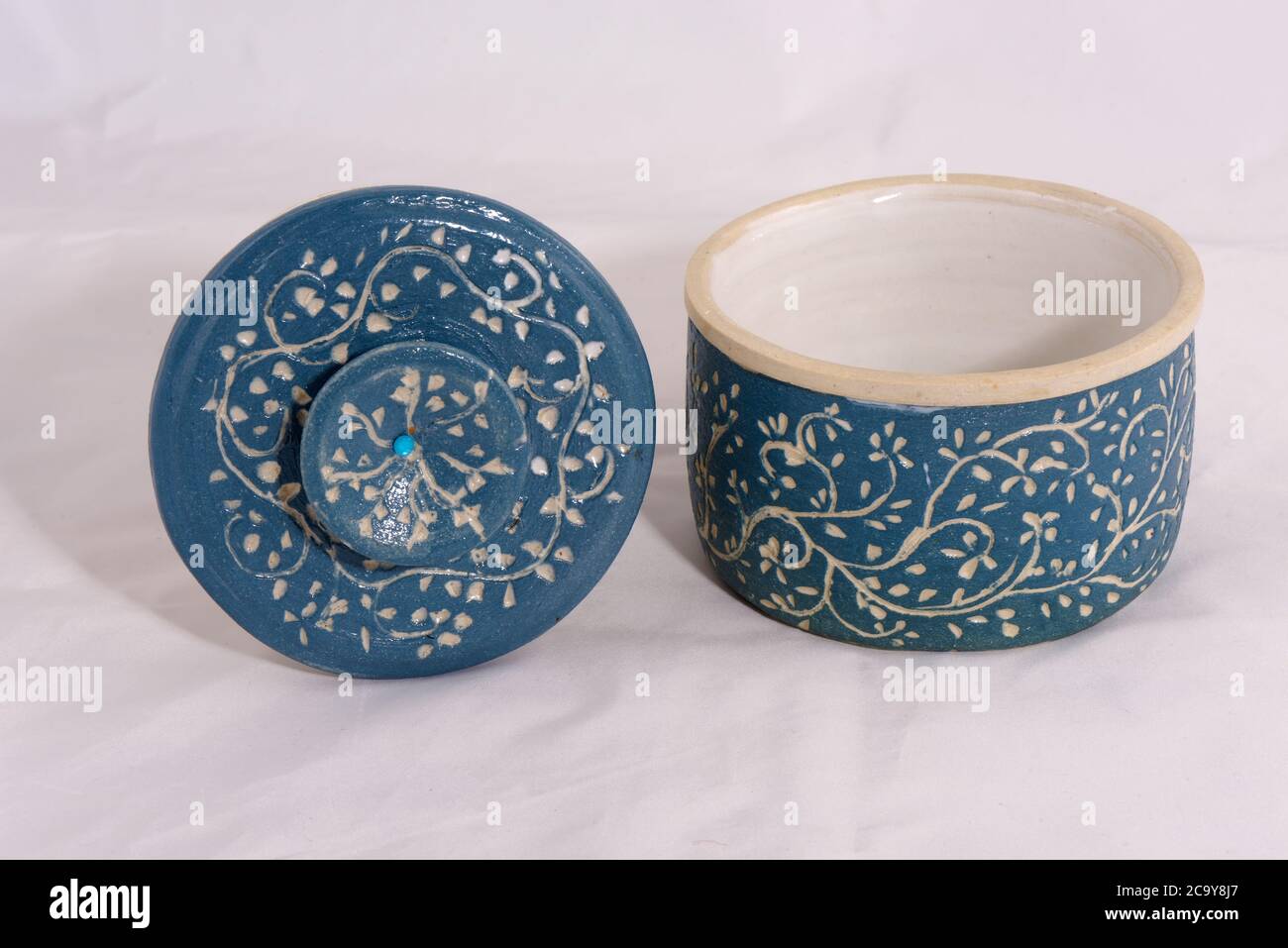 Hand made traditional ceramic butter bell pottery with blue finish and leaf pattern Stock Photo