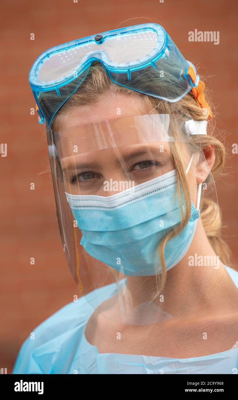 Salisbury, Wiltshire, UK. August 2020. Portarit of a woman Covid-19 tester wearing protective clothing, visor, mask, goggles at a testing station Stock Photo