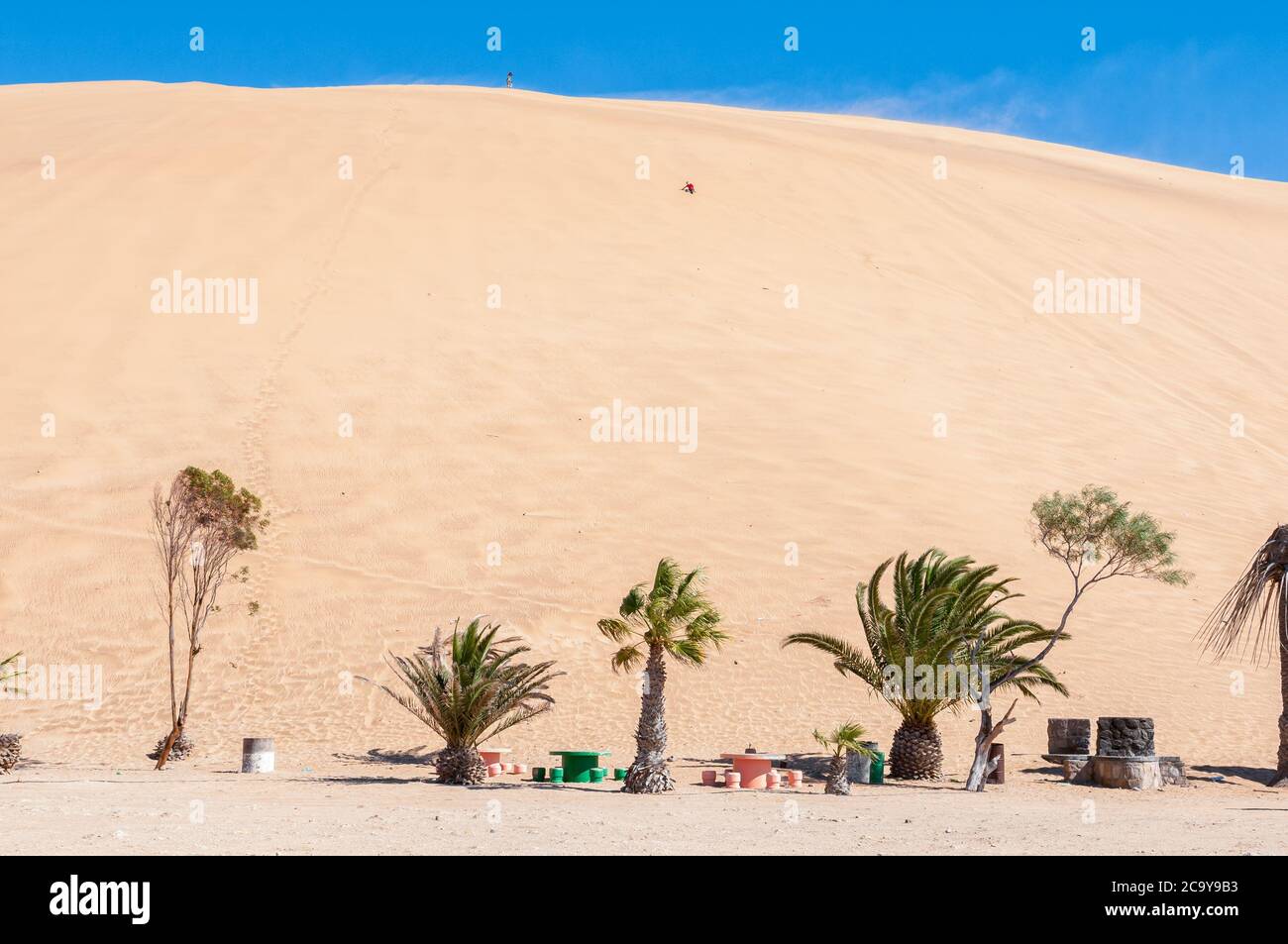 People are visible on Dune 7 at Walvis Bay on the Atlantic Ocean coast of Namibia Stock Photo