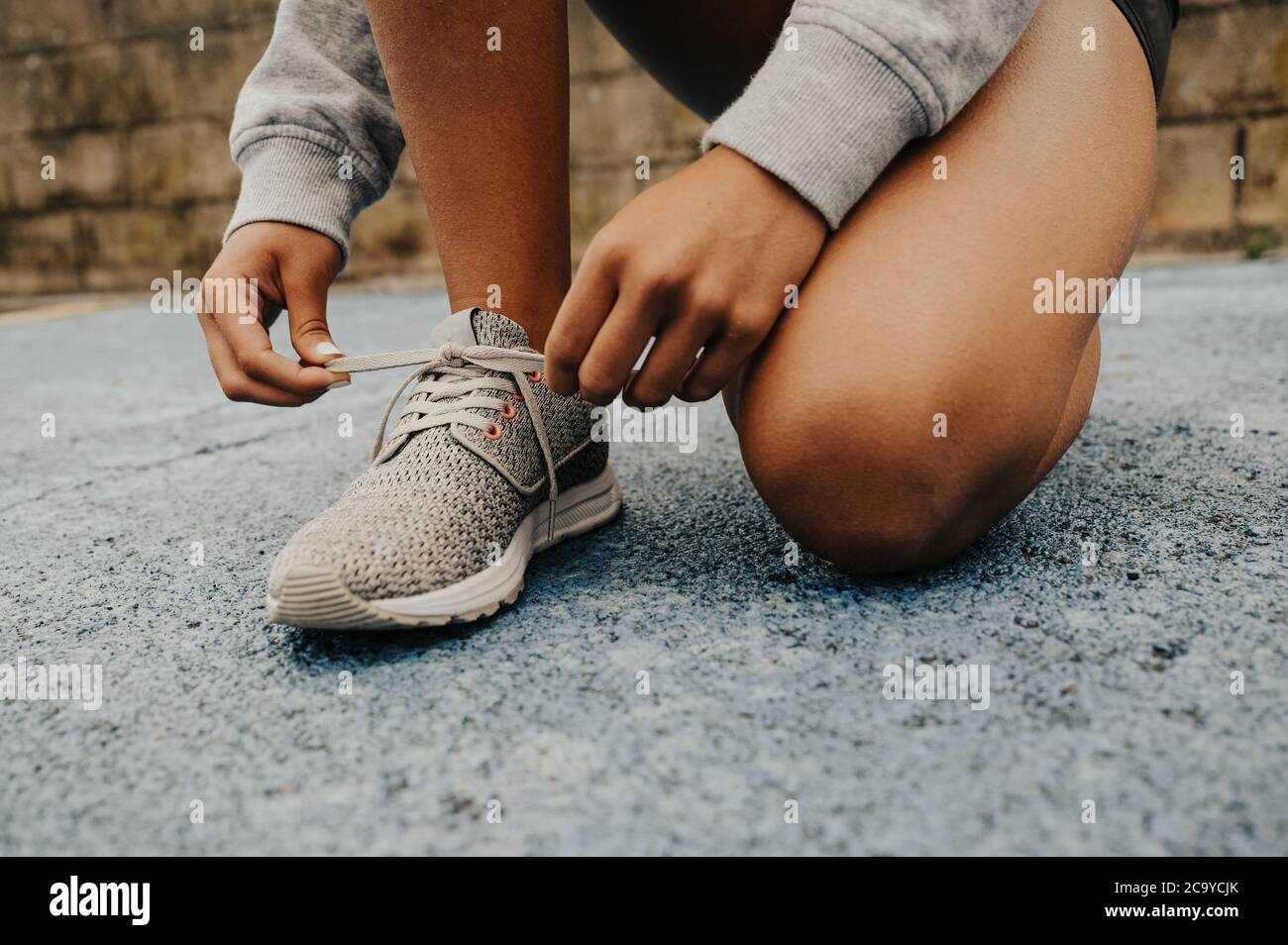 Attractive young girl running around in fitness clothes on a rainy day