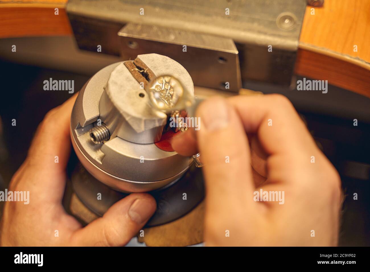 Jeweler holding a magnifying glass in his hand Stock Photo Alamy